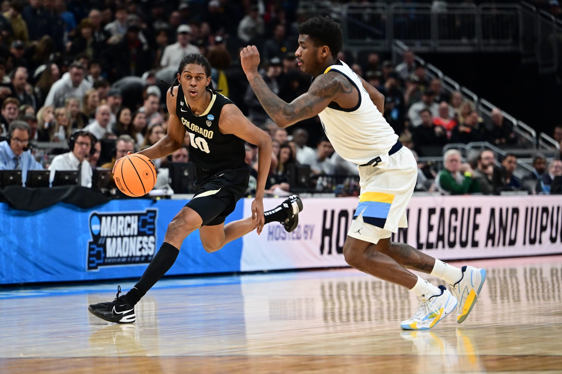 INDIANAPOLIS, INDIANA - MARCH 24: Cody Williams #10 of the Colorado Buffaloes drives the ball against Kam Jones #1 of the Marquette Golden Eagles during the second round of the 2024 NCAA Men's Basketball Tournament held at Gainbridge Fieldhouse on March 24, 2024 in Indianapolis, Indiana. (Photo by Ben Solomon/NCAA Photos via Getty Images)