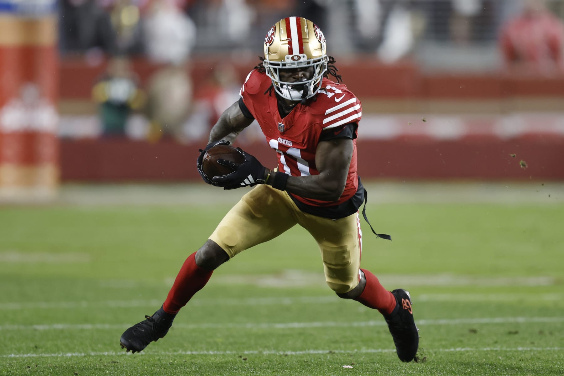 SANTA CLARA, CALIFORNIA - JANUARY 20: Brandon Aiyuk #11 of the San Francisco 49ers runs with the ball during the first half against the Green Bay Packers in the NFC Divisional Playoffs at Levi's Stadium on January 20, 2024 in Santa Clara, California. (Photo by Lachlan Cunningham/Getty Images)