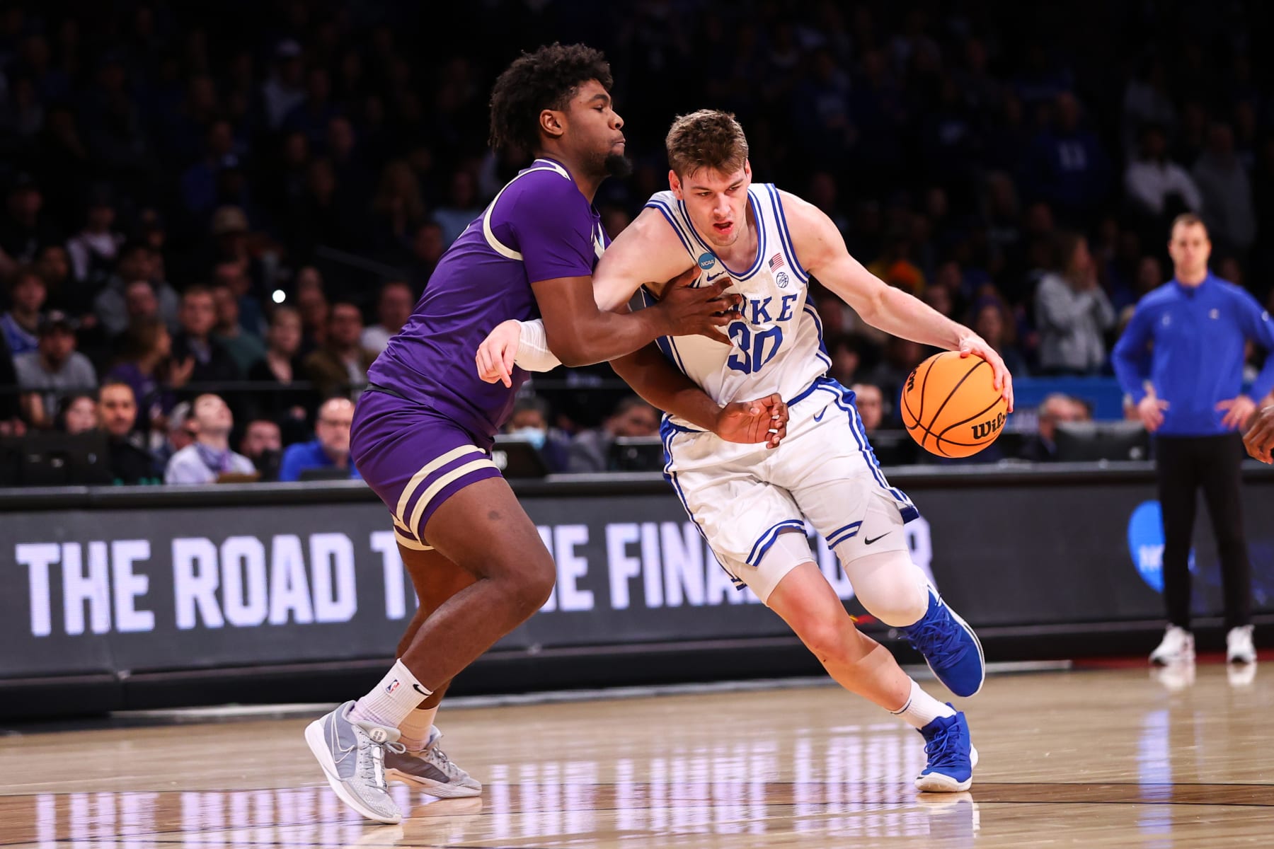 NEW YORK, NEW YORK - MARCH 24: Kyle Filipowski #30 of the Duke Blue Devils is guarded by  during the second round of the NCAA Men’s Basketball Tournament at Barclays Center on March 24, 2024 in New York City. (Photo by Jamie Schwaberow/NCAA Photos via Getty Images)
