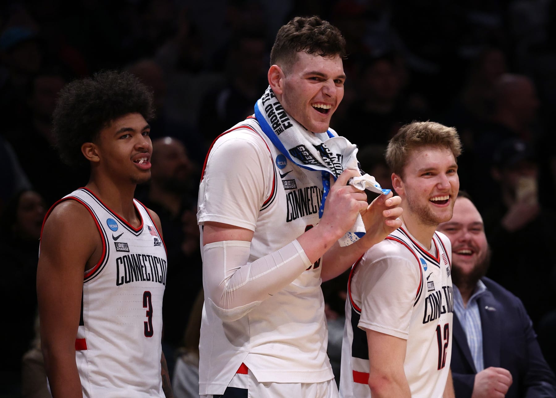 NEW YORK, NEW YORK - MARCH 24: Cam Spencer #12, Donovan Clingan #32, and Jaylin Stewart #3 of the Connecticut Huskies react after a 75-58 victory against the Northwestern Wildcats in the second round of the NCAA Men's Basketball Tournament at Barclays Center on March 24, 2024 in New York City. (Photo by Elsa/Getty Images)