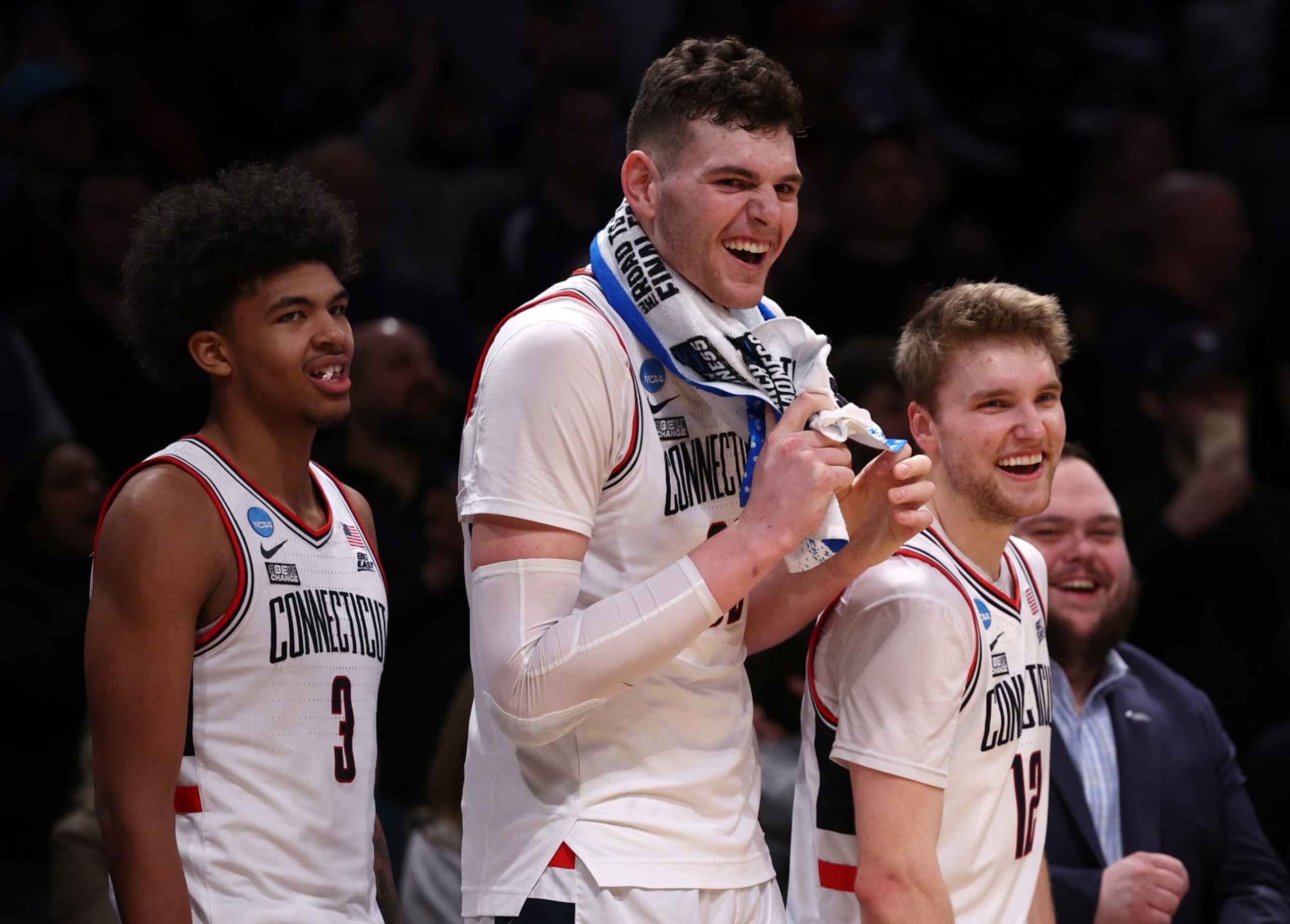 NEW YORK, NEW YORK - MARCH 24: Cam Spencer #12, Donovan Clingan #32, and Jaylin Stewart #3 of the Connecticut Huskies react after a 75-58 victory against the Northwestern Wildcats in the second round of the NCAA Men's Basketball Tournament at Barclays Center on March 24, 2024 in New York City. (Photo by Elsa/Getty Images)