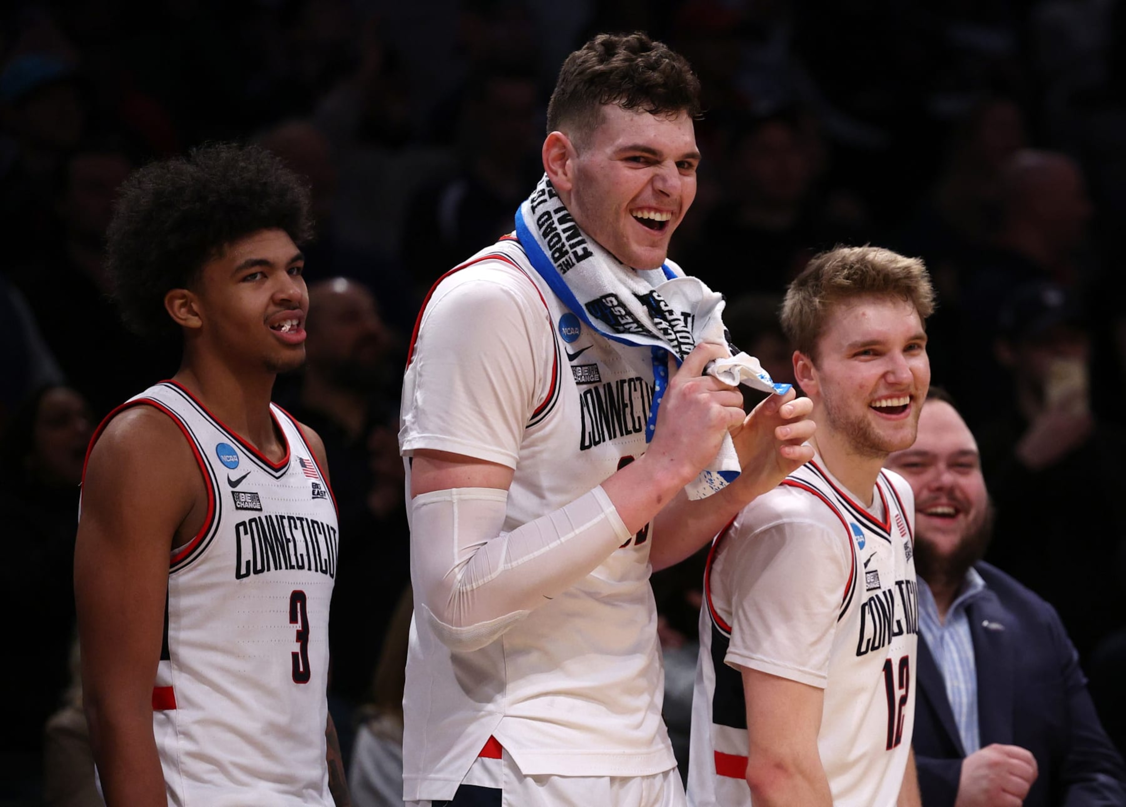 NEW YORK, NEW YORK - MARCH 24: Cam Spencer #12, Donovan Clingan #32, and Jaylin Stewart #3 of the Connecticut Huskies react after a 75-58 victory against the Northwestern Wildcats in the second round of the NCAA Men's Basketball Tournament at Barclays Center on March 24, 2024 in New York City. (Photo by Elsa/Getty Images)