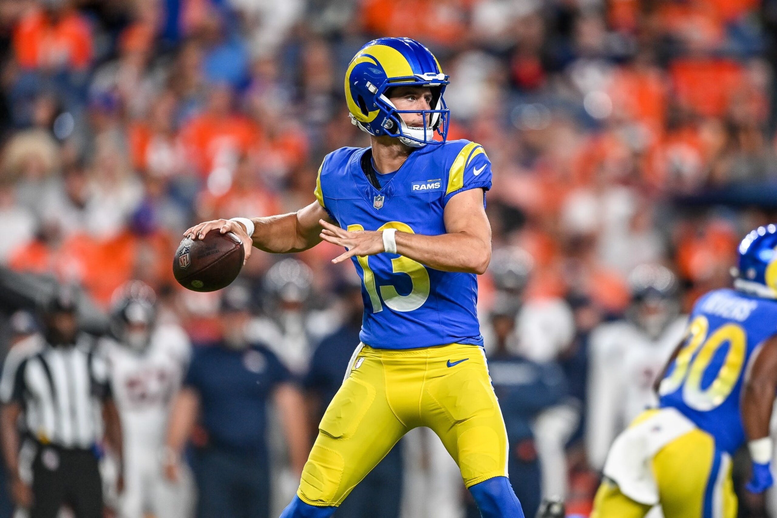 DENVER, COLORADO - AUGUST 26:  Quarterback Stetson Bennett #13 of the Los Angeles Rams passes against the Denver Broncos in the first quarter of a preseason game at Empower Field at Mile High on August 26, 2023 in Denver, Colorado. (Photo by Dustin Bradford/Getty Images)