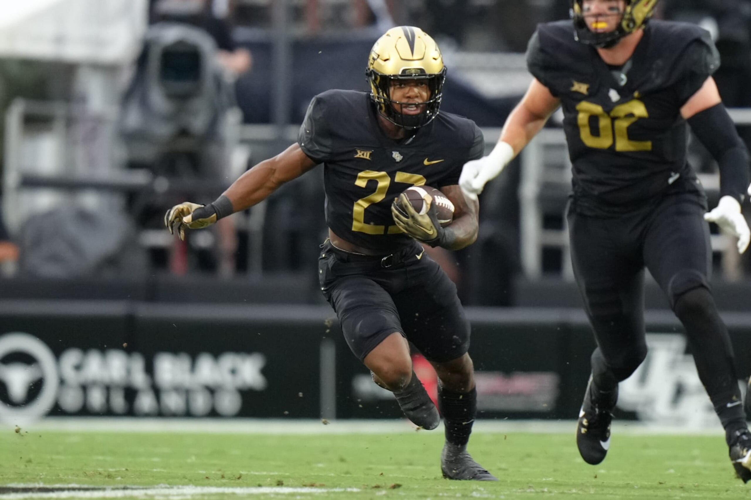 ORLANDO, FL - AUGUST 31: UCF Knights running back Demarkcus Bowman (23) rushes with the ball during the game between the Kent State Golden Flashes and the UCF Knights on Thursday, August 31, 2023 at FBC Mortgage Stadium, Orlando Fla. (Photo by Peter Joneleit/Icon Sportswire via Getty Images)