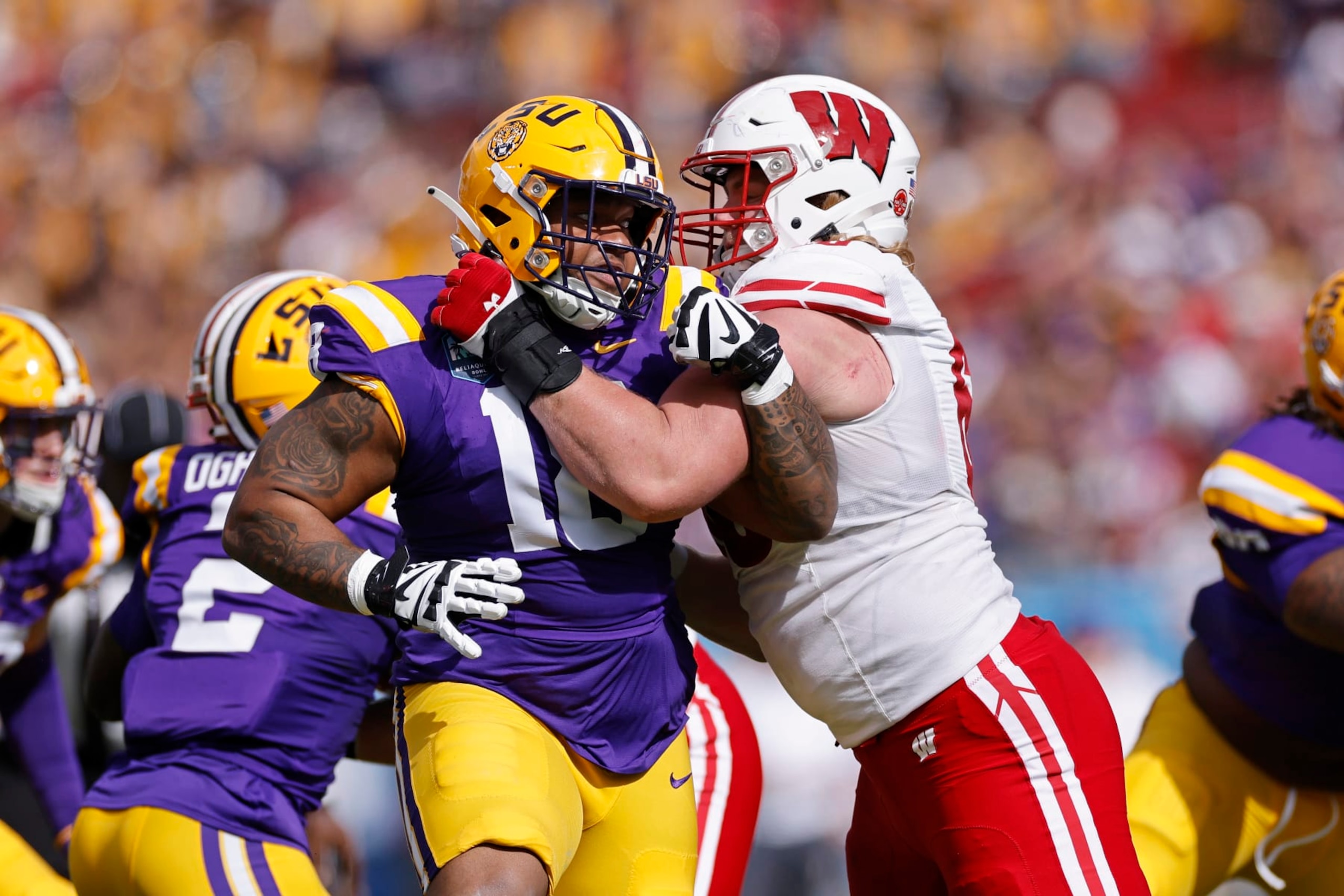 TAMPA, FL - JANUARY 01: LSU Tigers defensive tackle Mekhi Wingo (18) rushes against Wisconsin Badgers offensive lineman Nolan Rucci (66) during the ReliaQuest Bowl on January 1, 2024 at Raymond James Stadium in Tampa, Florida. (Photo by Joe Robbins/Icon Sportswire via Getty Images)