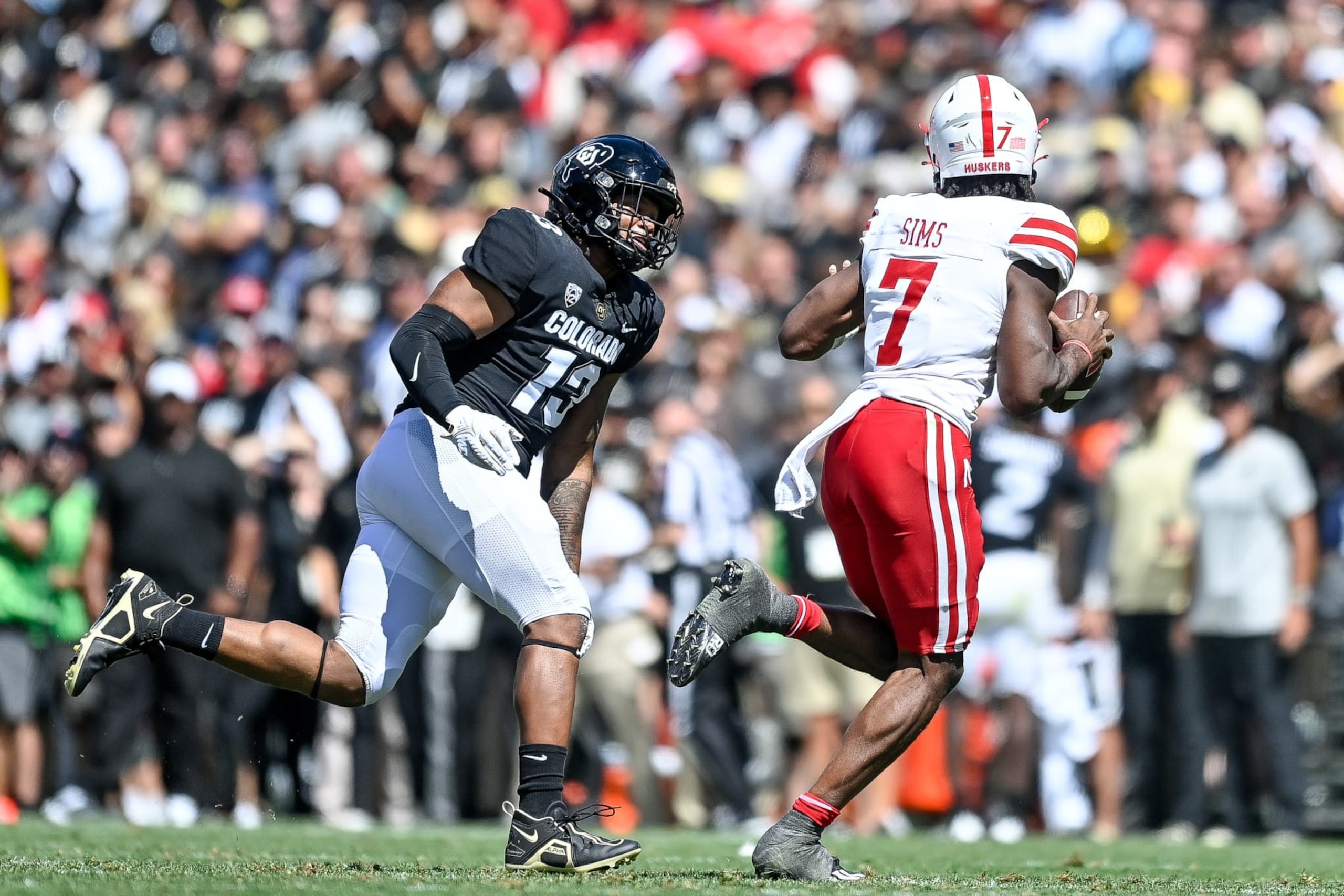 BOULDER, CO - SEPTEMBER 9:  Defensive end Sav'ell Smalls #13 of the Colorado Buffaloes pressures quarterback Jeff Sims #7 of the Nebraska Cornhuskers in the fourth quarter at Folsom Field on September 9, 2023 in Boulder, Colorado. (Photo by Dustin Bradford/Getty Images)
