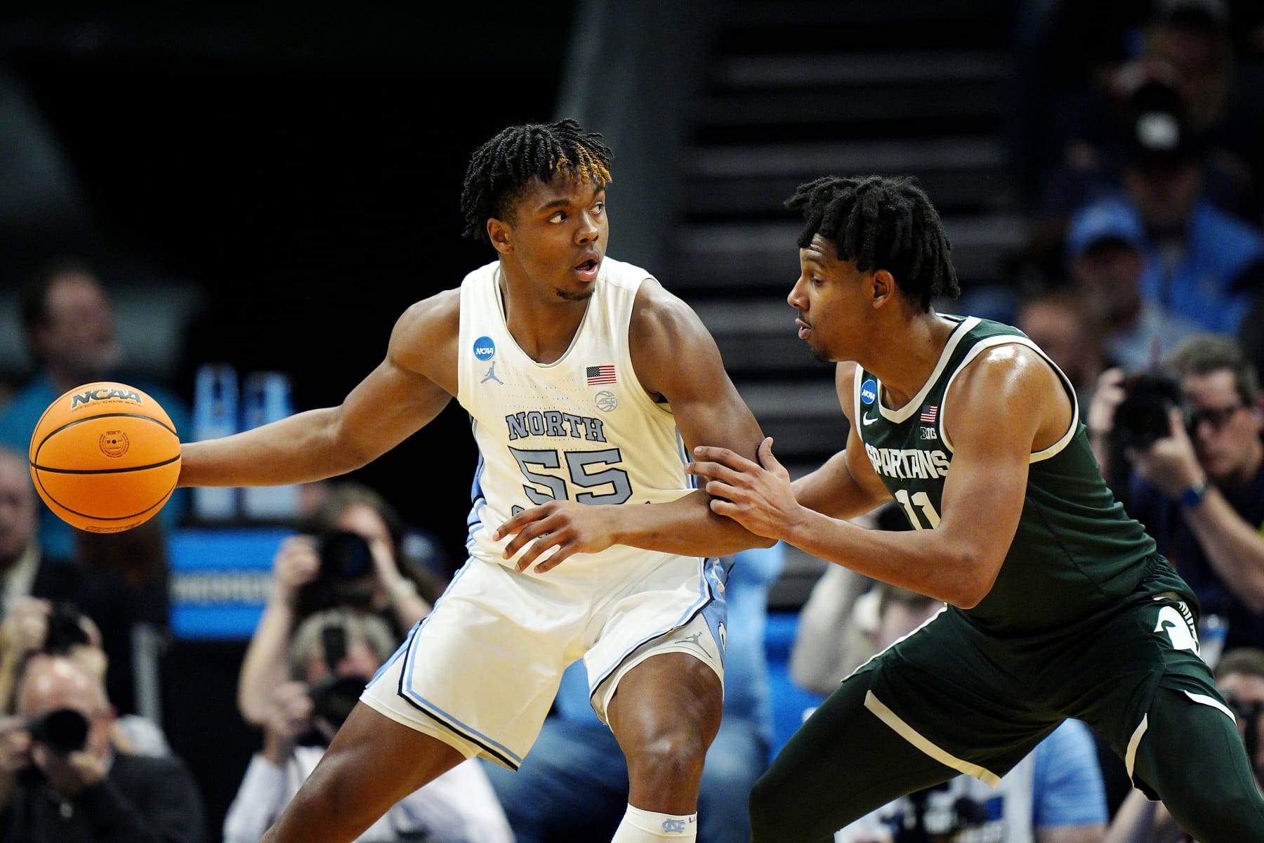 CHARLOTTE, NORTH CAROLINA - MARCH 23: Harrison Ingram #55 of the North Carolina Tar Heels dribbles the ball against A.J. Hoggard #11 of the Michigan State Spartans during the first half in the second round of the NCAA Men's Basketball Tournament at Spectrum Center on March 23, 2024 in Charlotte, North Carolina. (Photo by Jacob Kupferman/Getty Images)