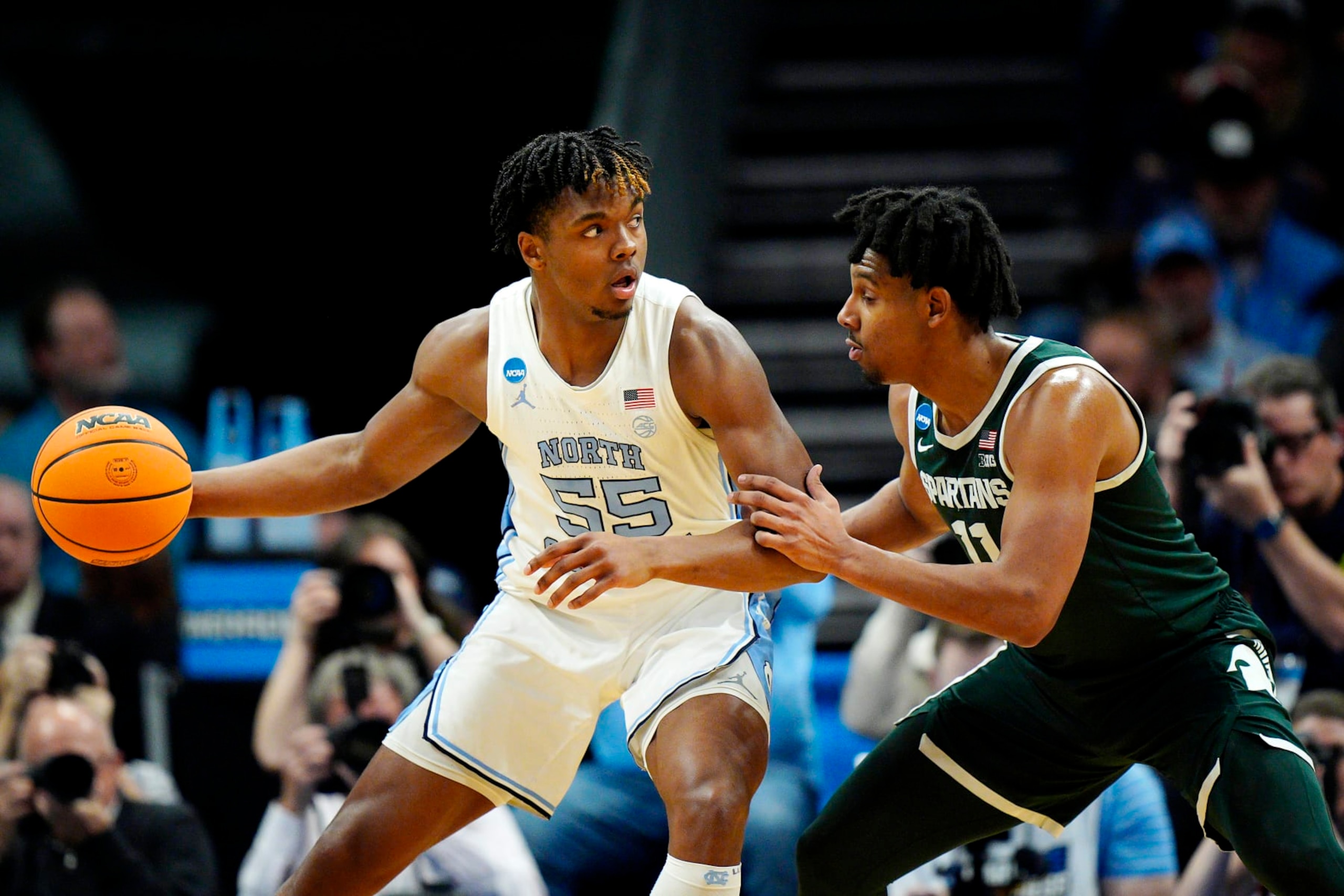 CHARLOTTE, NORTH CAROLINA - MARCH 23: Harrison Ingram #55 of the North Carolina Tar Heels dribbles the ball against A.J. Hoggard #11 of the Michigan State Spartans during the first half in the second round of the NCAA Men's Basketball Tournament at Spectrum Center on March 23, 2024 in Charlotte, North Carolina. (Photo by Jacob Kupferman/Getty Images)