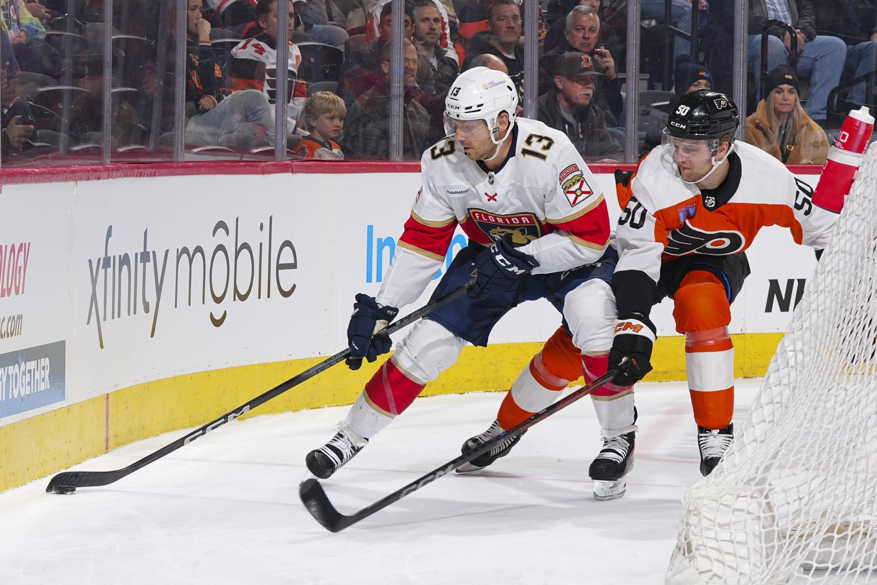 PHILADELPHIA, PENNSYLVANIA - MARCH 24: Sam Reinhart #13 of the Florida Panthers controls the puck against Adam Ginning #50 of the Philadelphia Flyers in the first period at the Wells Fargo Center on March 24, 2024 in Philadelphia, Pennsylvania. (Photo by Mitchell Leff/Getty Images)