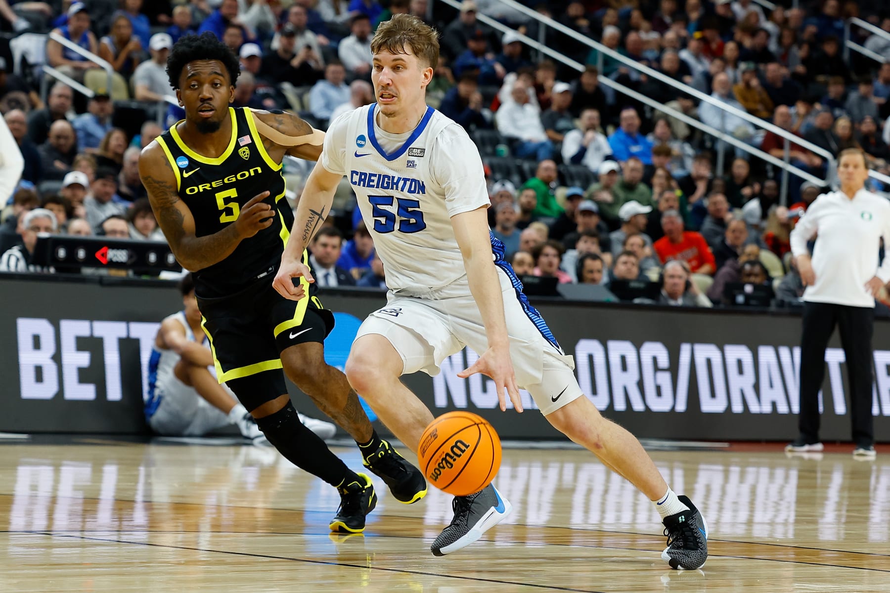 PITTSBURGH, PENNSYLVANIA - MARCH 23: Baylor Scheierman #55 of the Creighton Bluejays dribbles past Jermaine Couisnard #5 of the Oregon Ducks in the second half during the second round of the 2024 NCAA Men's Basketball Tournament held at PPG PAINTS Arena on March 23, 2024 in Pittsburgh, Pennsylvania. (Photo by Justin K. Aller/NCAA Photos via Getty Images)