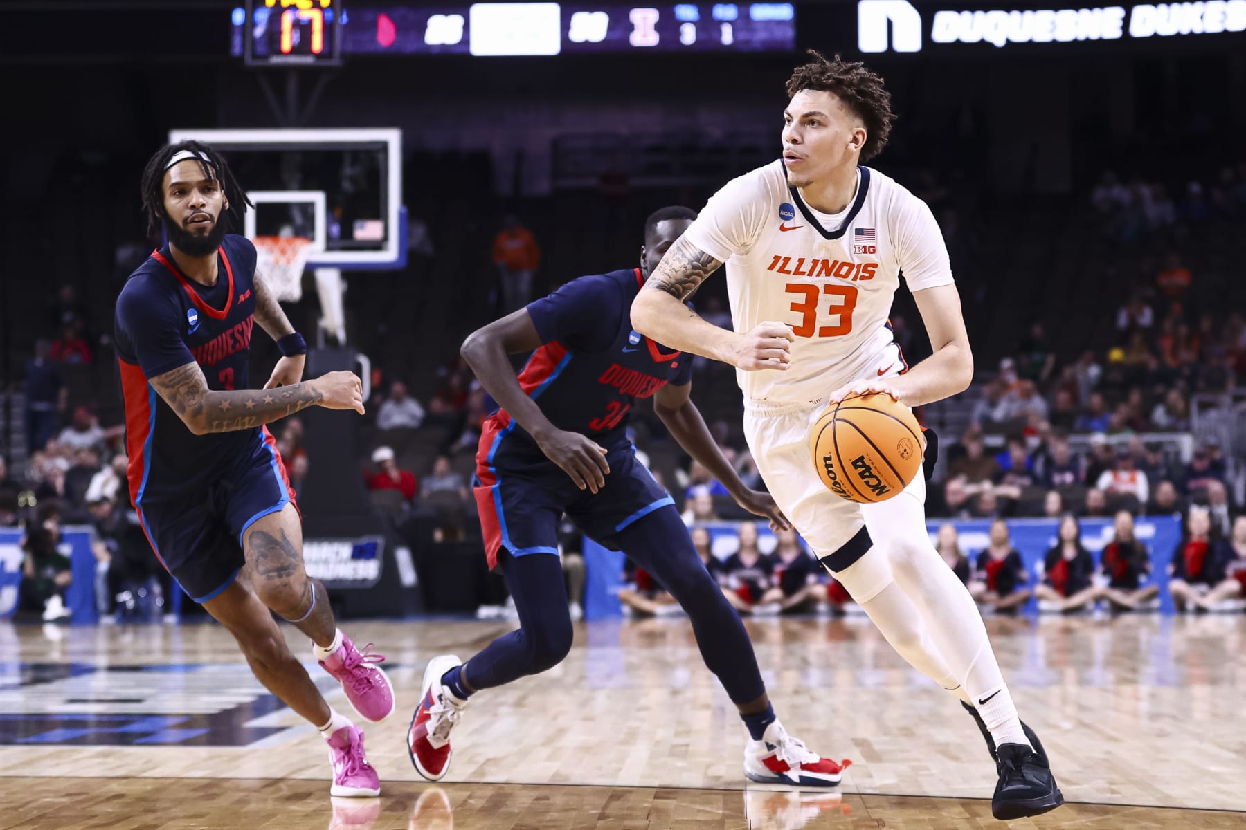 OMAHA, NEBRASKA - MARCH 23: Coleman Hawkins #33 of the Illinois Fighting Illini dribbles the ball during the second half of the game against the Duquesne Dukes during the second round of the 2024 NCAA Men's Basketball Tournament held at CHI Health Center on March 23, 2024 in Omaha, Nebraska. (Photo by Tyler Schank/NCAA Photos via Getty Images)
