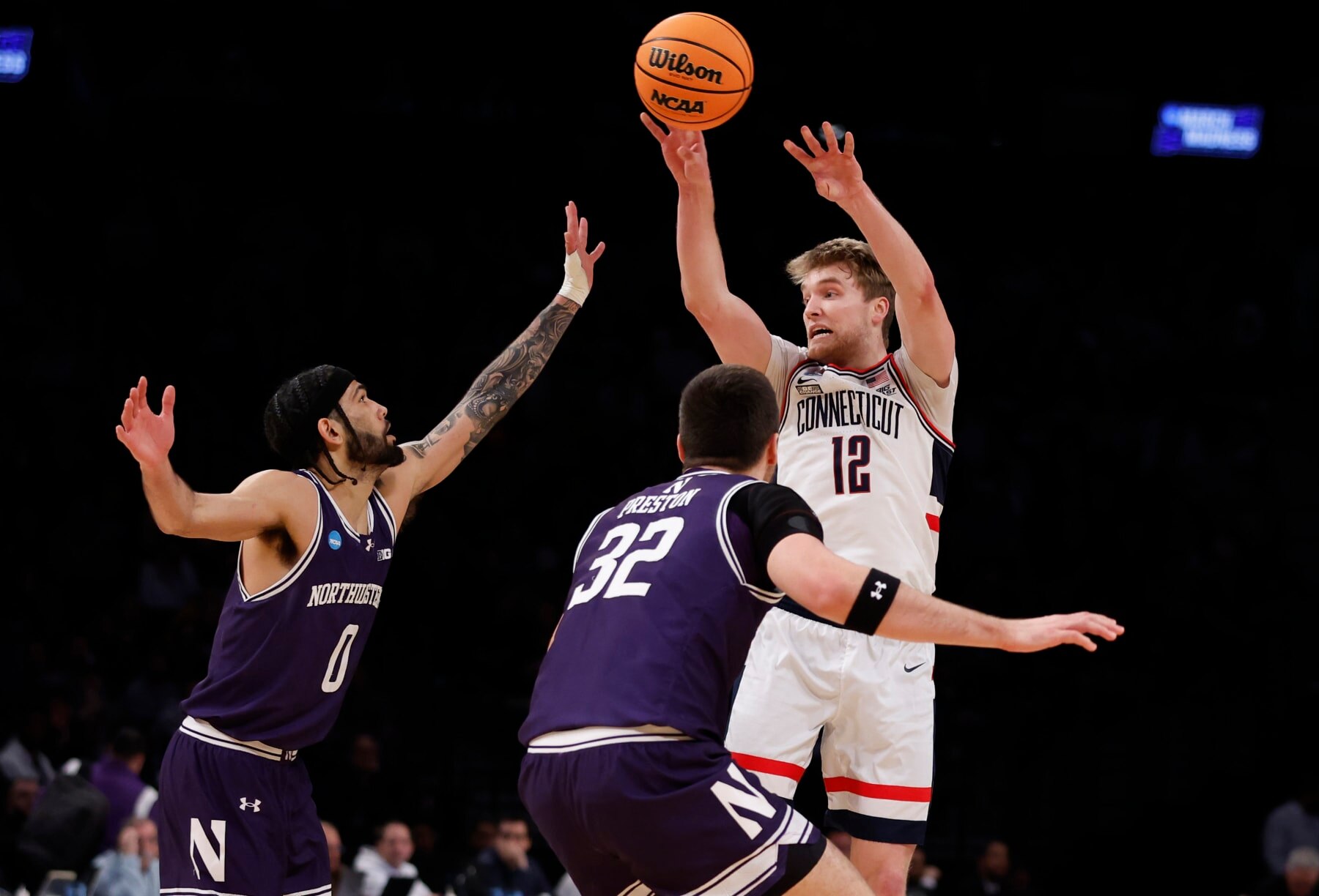 NEW YORK, NEW YORK - MARCH 24: Cam Spencer #12 of the Connecticut Huskies passes the ball during the first half against the Northwestern Wildcats in the second round of the NCAA Men's Basketball Tournament at Barclays Center on March 24, 2024 in New York City. (Photo by Sarah Stier/Getty Images)