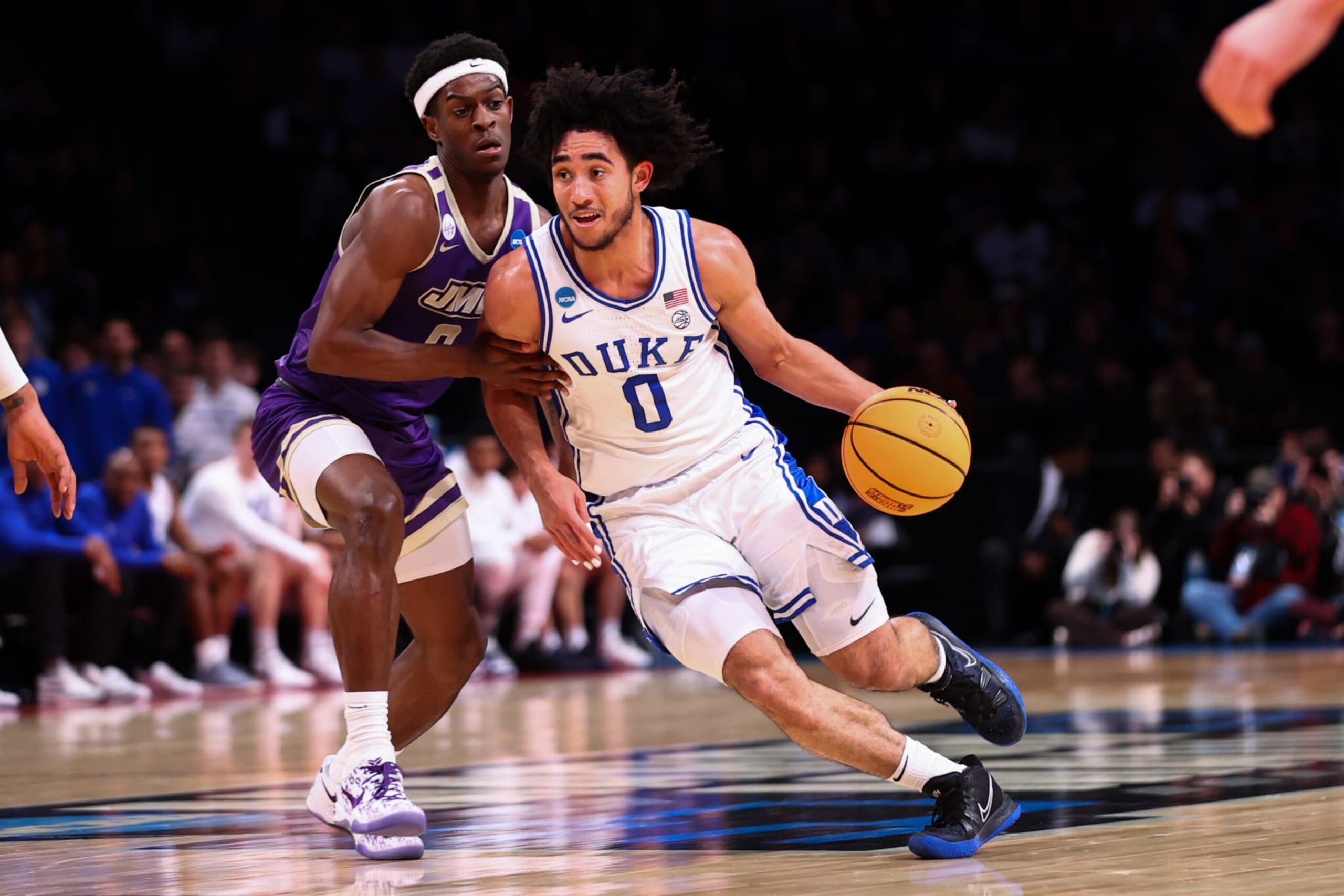 NEW YORK, NEW YORK - MARCH 24: Jared McCain #0 of the Duke Blue Devils is defended by Xavier Brown #0 of the James Madison Dukes during the first half of the game  during the second round of the NCAA Men’s Basketball Tournament at Barclays Center on March 24, 2024 in New York City. (Photo by Jamie Schwaberow/NCAA Photos via Getty Images)