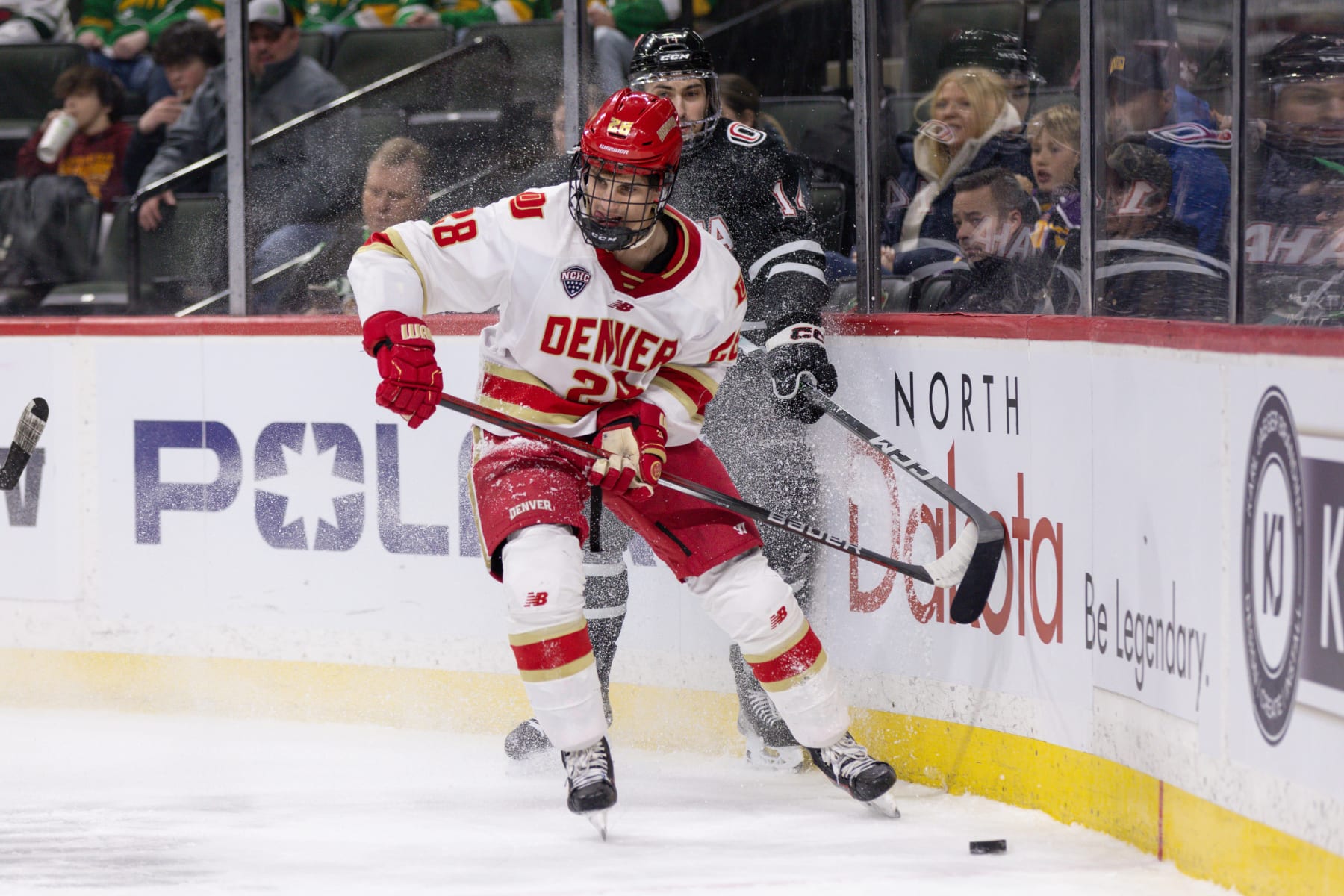 SAINT PAUL, MN - MARCH 23: Denver Pioneers defenseman Zeev Buium (28) skates with the puck while being defended by Omaha Mavericks forward Jesse Lansdell (14) during first period of a NCHC Frozen Faceoff championship game between the Omaha Mavericks and Denver Pioneers on March 23, 2024, at the Xcel Energy Center in Saint Paul, MN. (Photo by Bailey Hillesheim/Icon Sportswire via Getty Images)