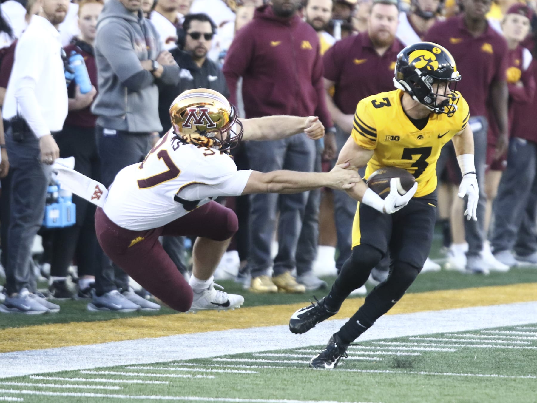 IOWA CITY, IOWA- OCTOBER 21:  Defensive back Cooper DeJean #3 of the Iowa Hawkeyes breaks a tackle during a called-back touchdown kick return during the second half by long snapper Brady Weeks #37 of the Minnesota Golden Gophers at Kinnick Stadium on October 21, 2023 in Iowa City, Iowa.  (Photo by Matthew Holst/Getty Images)