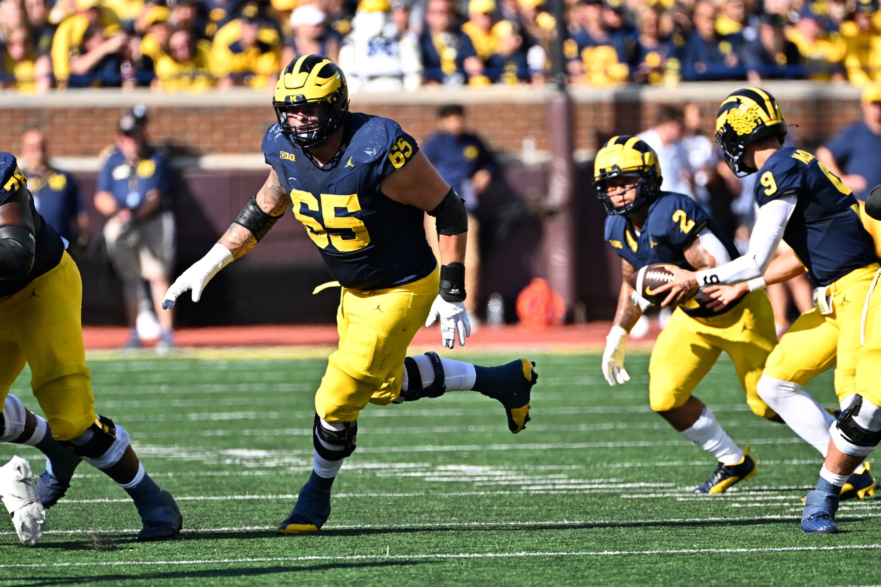 ANN ARBOR, MI - SEPTEMBER 09: Michigan Wolverines offensive lineman Zak Zinter (65) leads a running play during the game between the University of Michigan Wolverines versus UNLV Rebels on Saturday September 9, 2023 at Michigan Stadium, Ann Arbor, MI. (Photo by Steven King/Icon Sportswire via Getty Images)