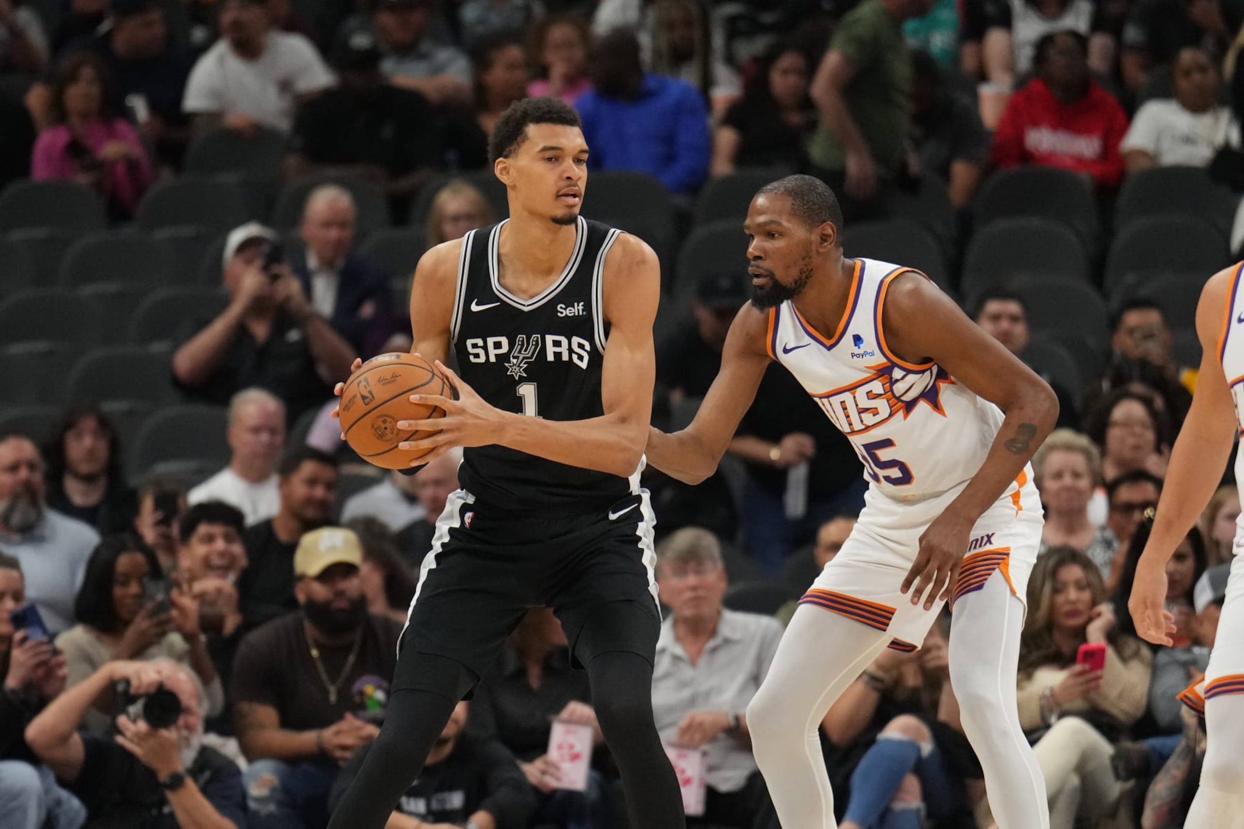 SAN ANTONIO, TX - MARCH 23: Victor Wembanyama #1 of the San Antonio Spurs handles the ball during the game against Kevin Durant #35 of the Phoenix Suns on March 23, 2024 at the Frost Bank Center in San Antonio, Texas. NOTE TO USER: User expressly acknowledges and agrees that, by downloading and or using this photograph, user is consenting to the terms and conditions of the Getty Images License Agreement. Mandatory Copyright Notice: Copyright 2024 NBAE (Photos by Jesse D. Garrabrant/NBAE via Getty Images)