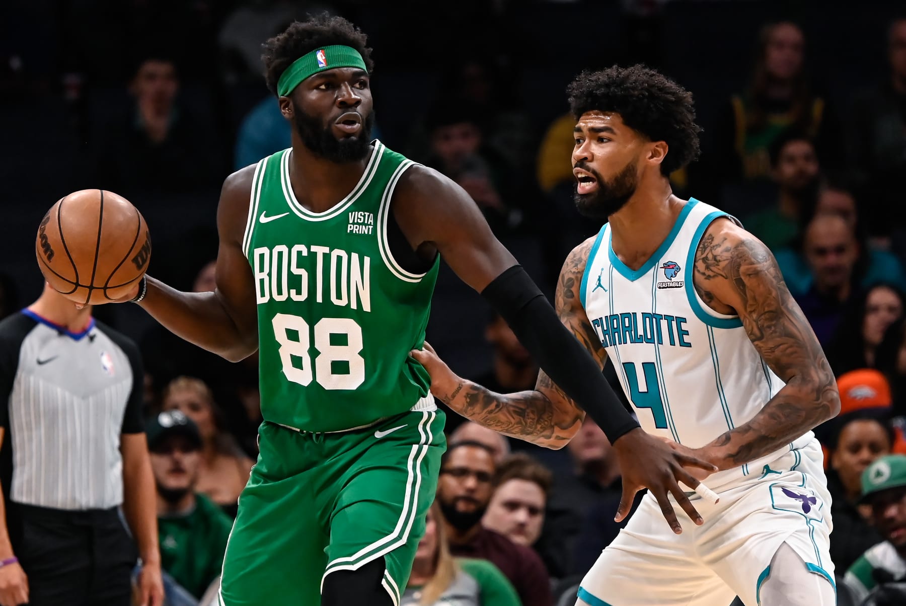 CHARLOTTE, NORTH CAROLINA - OCTOBER 19: Nick Richards #4 of the Charlotte Hornets defends Neemias Queta #88 of the Boston Celtics during the first half of his preseason game at Spectrum Center on October 19, 2023 in Charlotte, North Carolina. NOTE TO USER: User expressly acknowledges and agrees that, by downloading and or using this photograph, User is consenting to the terms and conditions of the Getty Images License Agreement.  (Photo by Matt Kelley/Getty Images)
