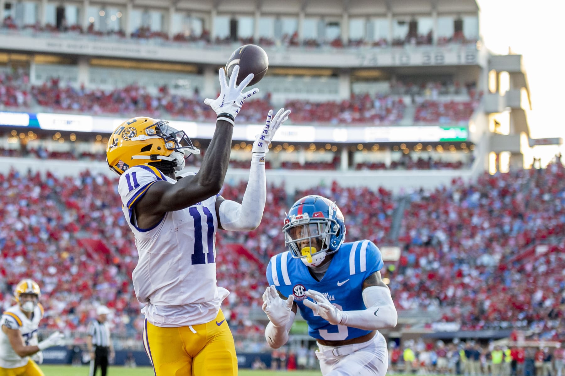 OXFORD, MISSISSIPPI - SEPTEMBER 30: Wide receiver Brian Thomas Jr. #11 of the LSU Tigers looks to catch a pass in front of safety Daijahn Anthony #3 of the Mississippi Rebels at Vaught-Hemingway Stadium on September 30, 2023 in Oxford, Mississippi. (Photo by Michael Chang/Getty Images)