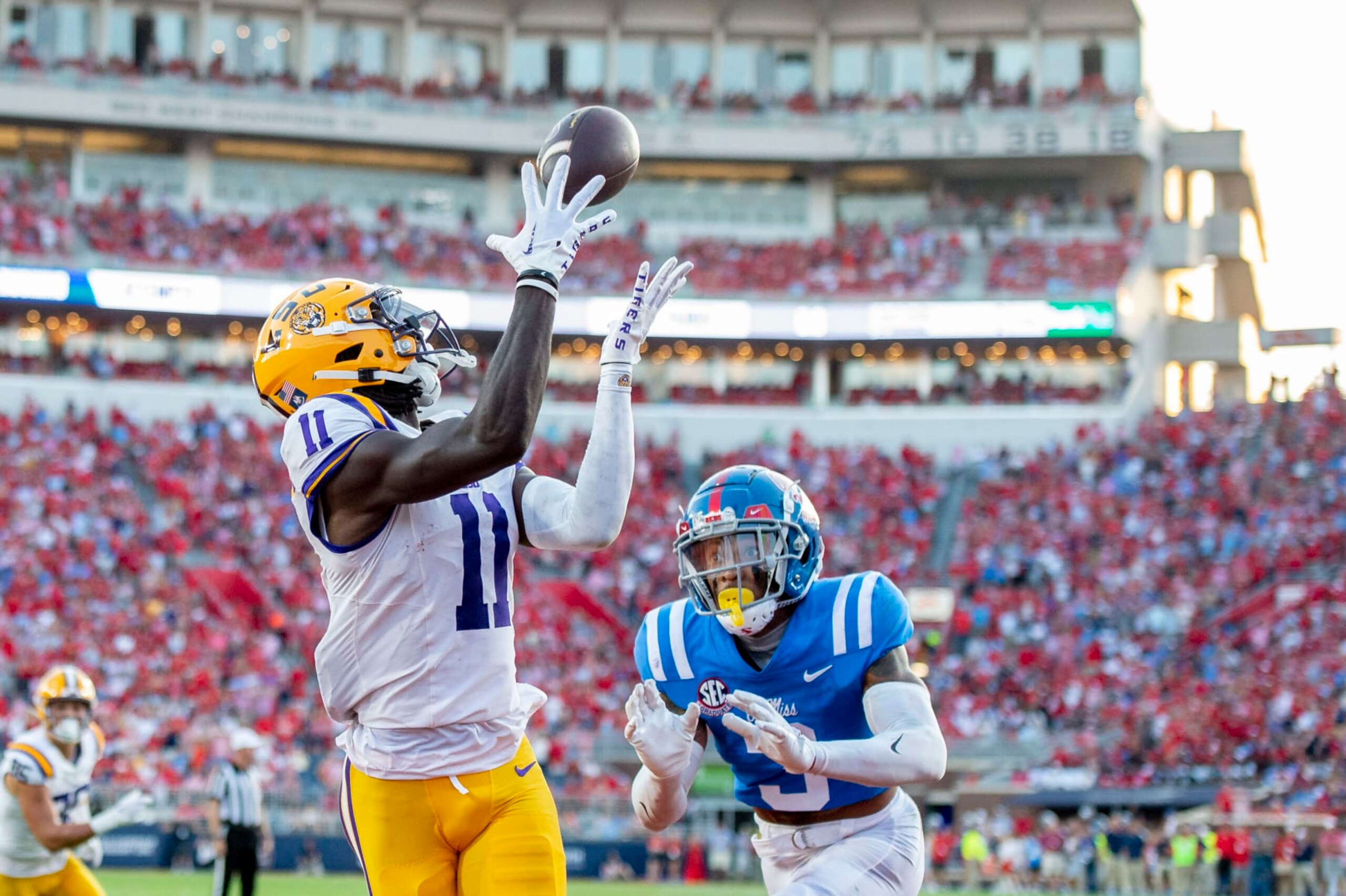 OXFORD, MISSISSIPPI - SEPTEMBER 30: Wide receiver Brian Thomas Jr. #11 of the LSU Tigers looks to catch a pass in front of safety Daijahn Anthony #3 of the Mississippi Rebels at Vaught-Hemingway Stadium on September 30, 2023 in Oxford, Mississippi. (Photo by Michael Chang/Getty Images)