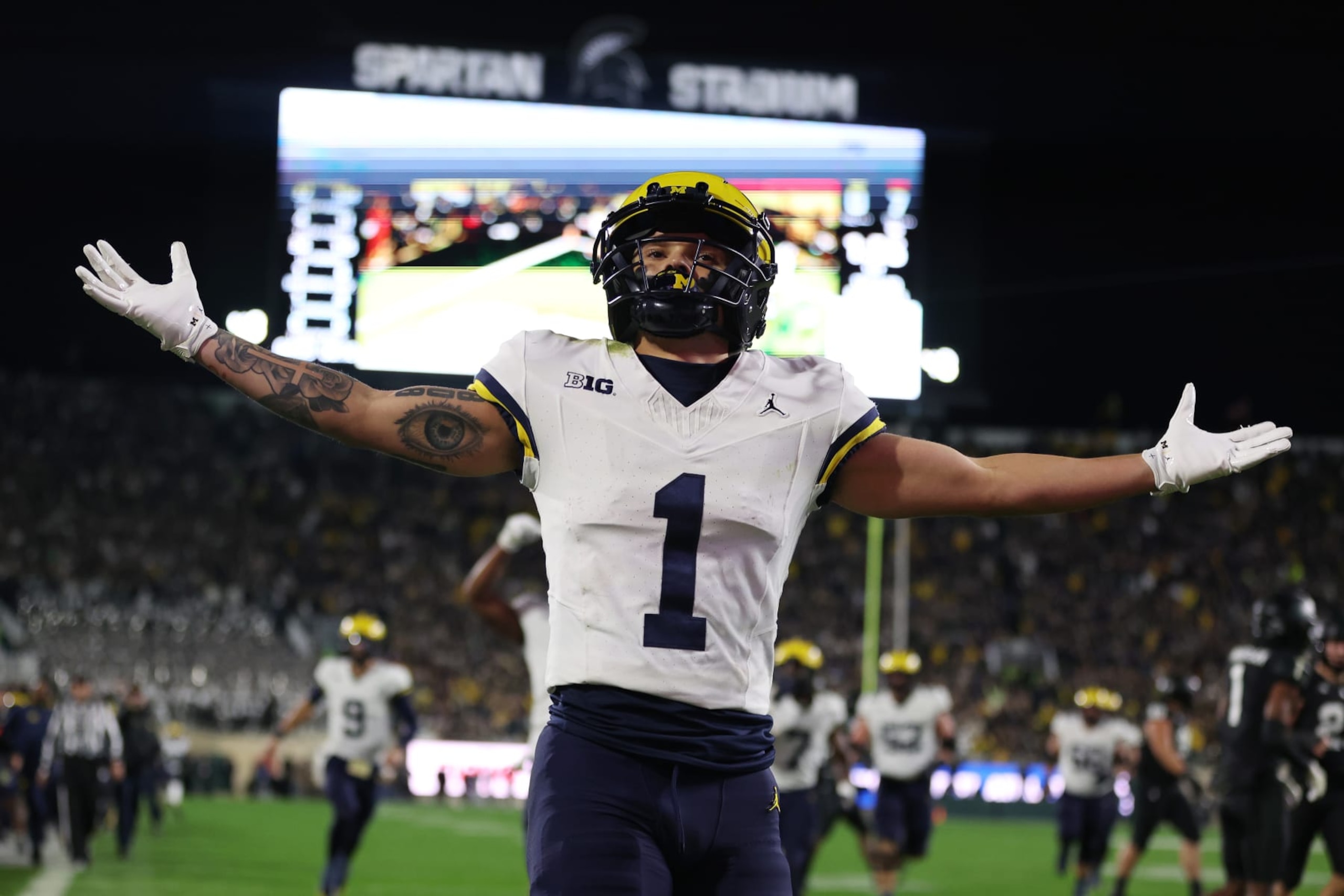 EAST LANSING, MICHIGAN - OCTOBER 21: Roman Wilson #1 of the Michigan Wolverines celebrates a first half touchdown against the Michigan State Spartans at Spartan Stadium on October 21, 2023 in East Lansing, Michigan. (Photo by Gregory Shamus/Getty Images)