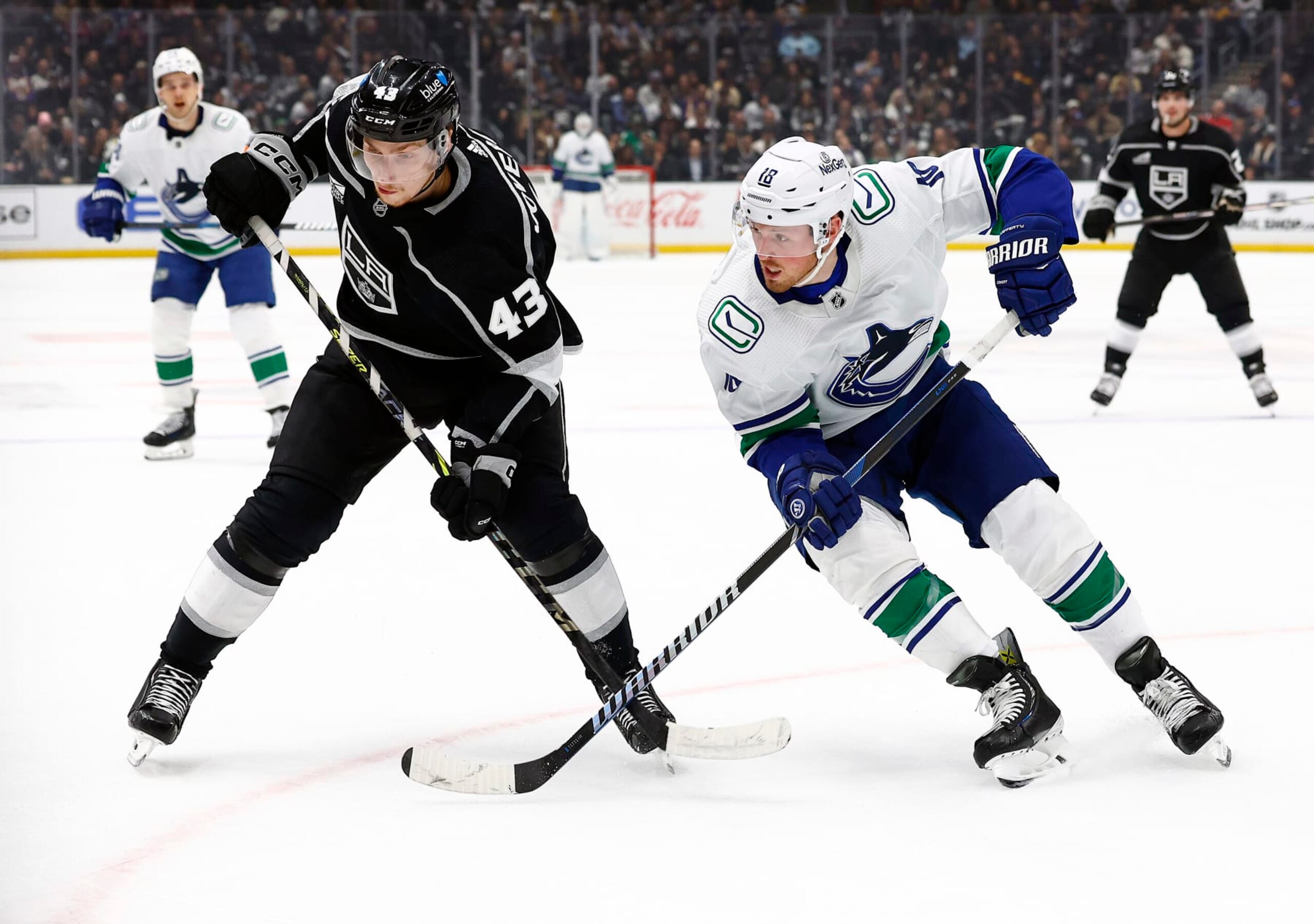 LOS ANGELES, CALIFORNIA - MARCH 05:  Jacob Moverare #43 of the Los Angeles Kings skates for the puck against Sam Lafferty #18 of the Vancouver Canucks in the first period at Crypto.com Arena on March 05, 2024 in Los Angeles, California. (Photo by Ronald Martinez/Getty Images)
