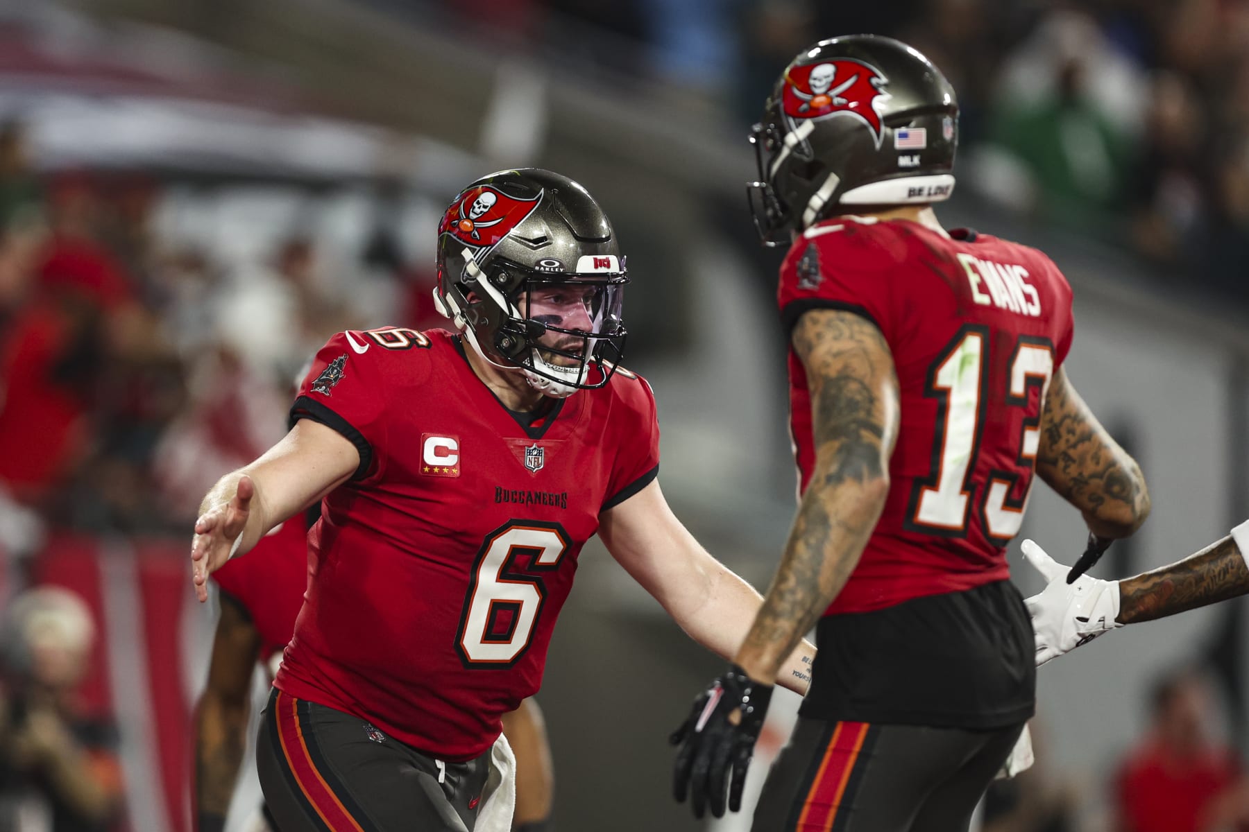 TAMPA, FL - JANUARY 15: Baker Mayfield #6 of the Tampa Bay Buccaneers celebrates with Mike Evans #13 during an NFL Wild Card playoff football game against the Philadelphia Eagles at Raymond James Stadium on January 15, 2024 in Tampa, Florida. (Photo by Perry Knotts/Getty Images)