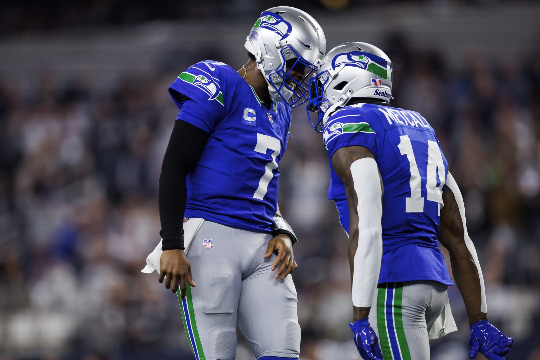 ARLINGTON, TEXAS - NOVEMBER 30: Geno Smith #7 of the Seattle Seahawks celebrates with DK Metcalf #14 of the Seattle Seahawks after scoring a touchdown during an NFL football game against the Dallas Cowboys at AT&T Stadium on November 30, 2023 in Arlington, Texas. (Photo by Ryan Kang/Getty Images)