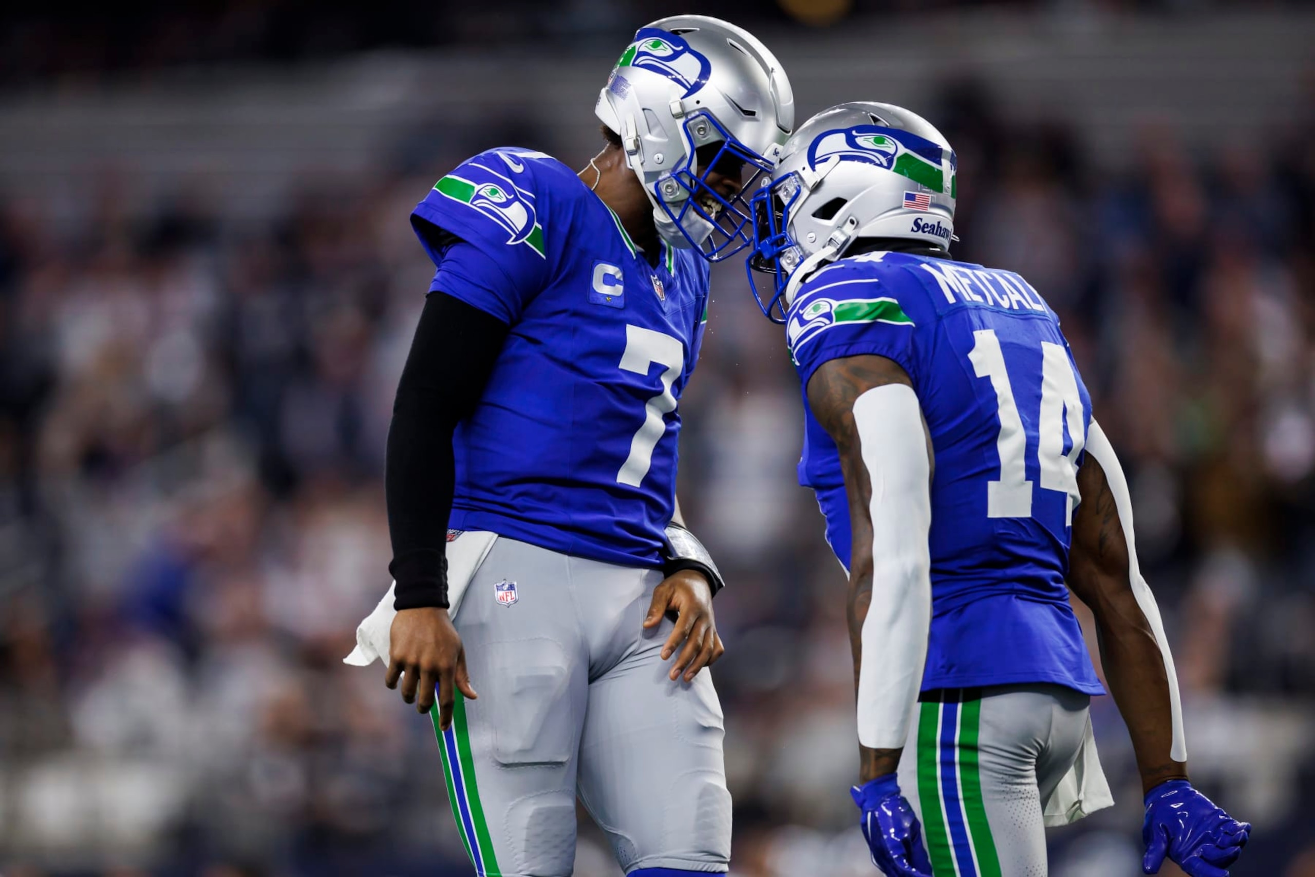 ARLINGTON, TEXAS - NOVEMBER 30: Geno Smith #7 of the Seattle Seahawks celebrates with DK Metcalf #14 of the Seattle Seahawks after scoring a touchdown during an NFL football game against the Dallas Cowboys at AT&T Stadium on November 30, 2023 in Arlington, Texas. (Photo by Ryan Kang/Getty Images) ARLINGTON, TEXAS - NOVEMBER 30: Geno Smith #7 of the Seattle Seahawks celebrates with DK Metcalf #14 of the Seattle Seahawks after scoring a touchdown during an NFL football game against the Dallas Cowboys at AT&T Stadium on November 30, 2023 in Arlington, Texas. (Photo by Ryan Kang/Getty Images)