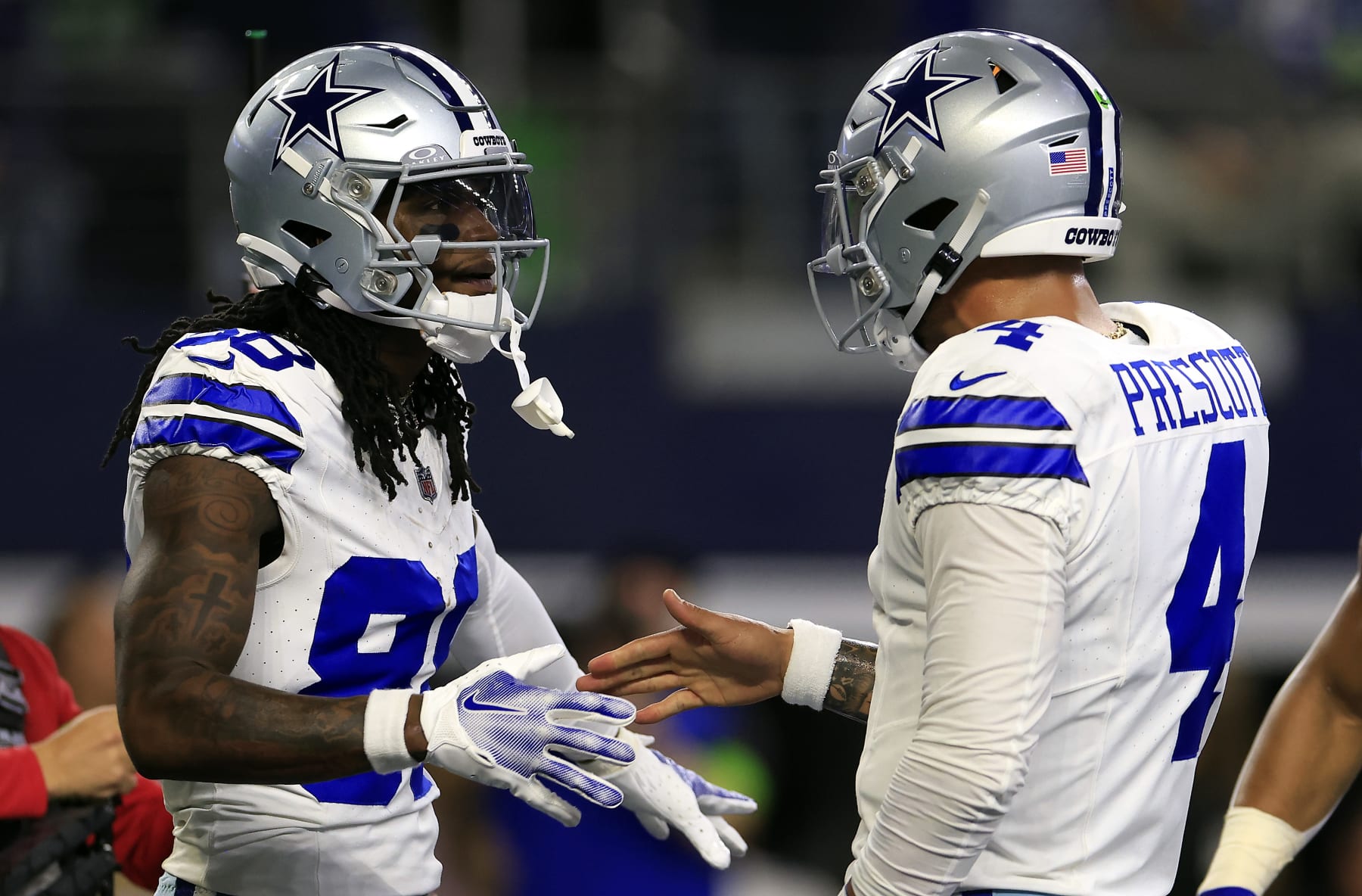 ARLINGTON, TEXAS - NOVEMBER 30:  Wide receiver CeeDee Lamb #88 of the Dallas Cowboys is congratulated by quarterback Dak Prescott #4 after catching a pass in the end zone for a touchdown during the 1st quarter of the game against the Seattle Seahawks at AT&T Stadium on November 30, 2023 in Arlington, Texas. (Photo by Ron Jenkins/Getty Images)