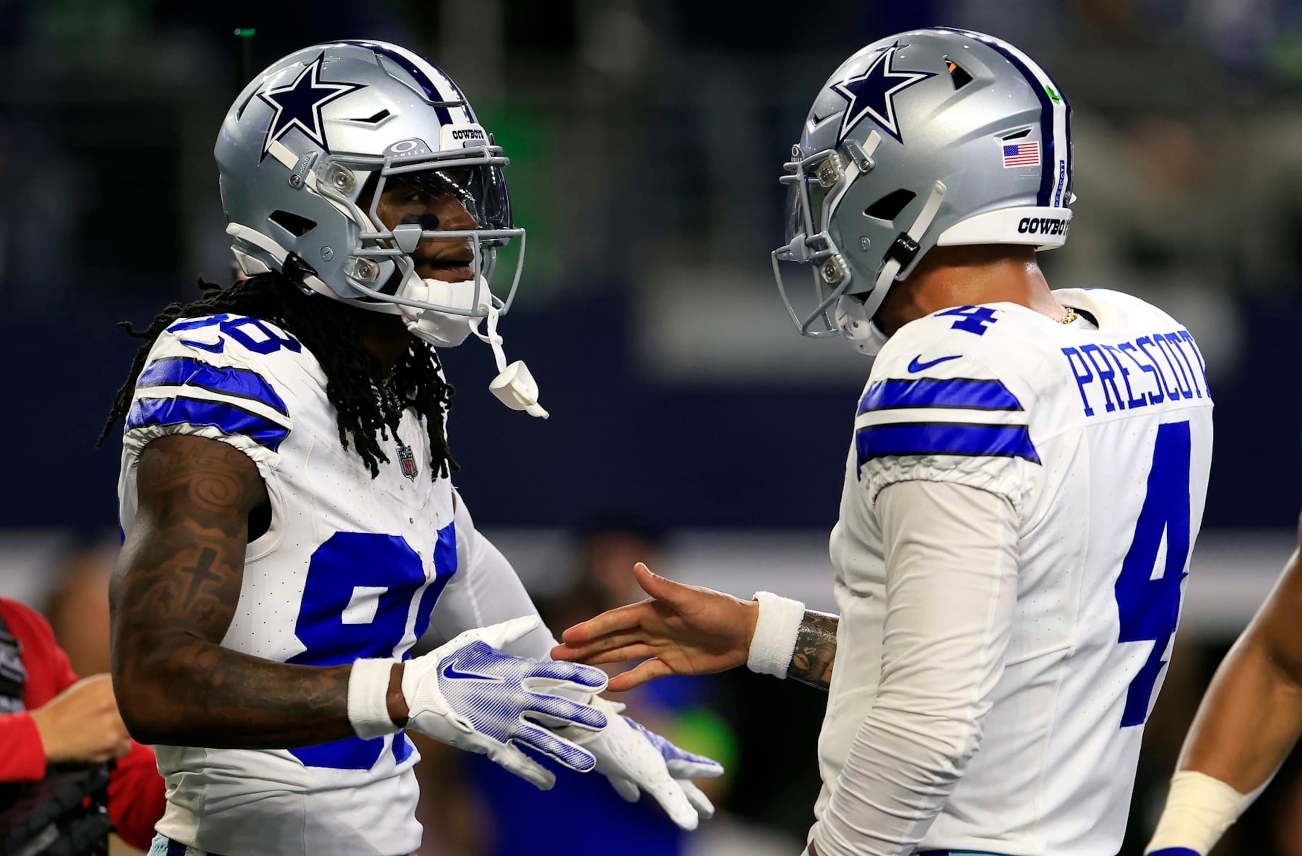 ARLINGTON, TEXAS - NOVEMBER 30: Wide receiver CeeDee Lamb #88 of the Dallas Cowboys is congratulated by quarterback Dak Prescott #4 after catching a pass in the end zone for a touchdown during the 1st quarter of the game against the Seattle Seahawks at AT&T Stadium on November 30, 2023 in Arlington, Texas. (Photo by Ron Jenkins/Getty Images) ARLINGTON, TEXAS - NOVEMBER 30: Wide receiver CeeDee Lamb #88 of the Dallas Cowboys is congratulated by quarterback Dak Prescott #4 after catching a pass in the end zone for a touchdown during the 1st quarter of the game against the Seattle Seahawks at AT&T Stadium on November 30, 2023 in Arlington, Texas. (Photo by Ron Jenkins/Getty Images)
