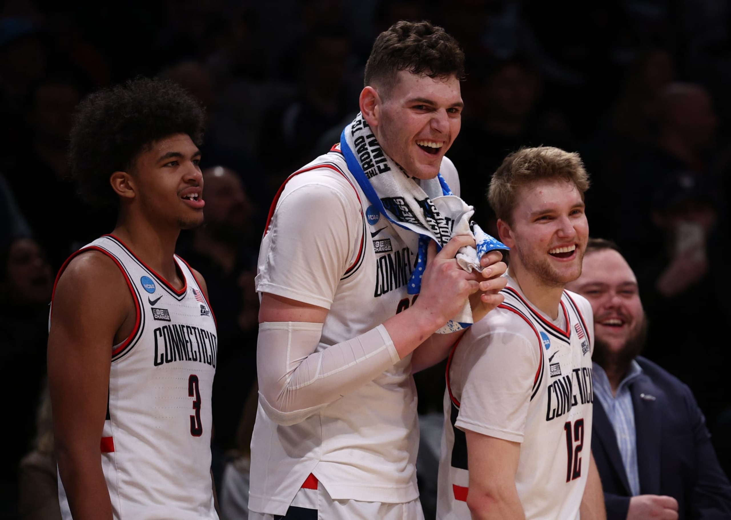 NEW YORK, NEW YORK - MARCH 24: Cam Spencer #12, Donovan Clingan #32, and Jaylin Stewart #3 of the Connecticut Huskies react after a 75-58 victory against the Northwestern Wildcats in the second round of the NCAA Men's Basketball Tournament at Barclays Center on March 24, 2024 in New York City. (Photo by Elsa/Getty Images)