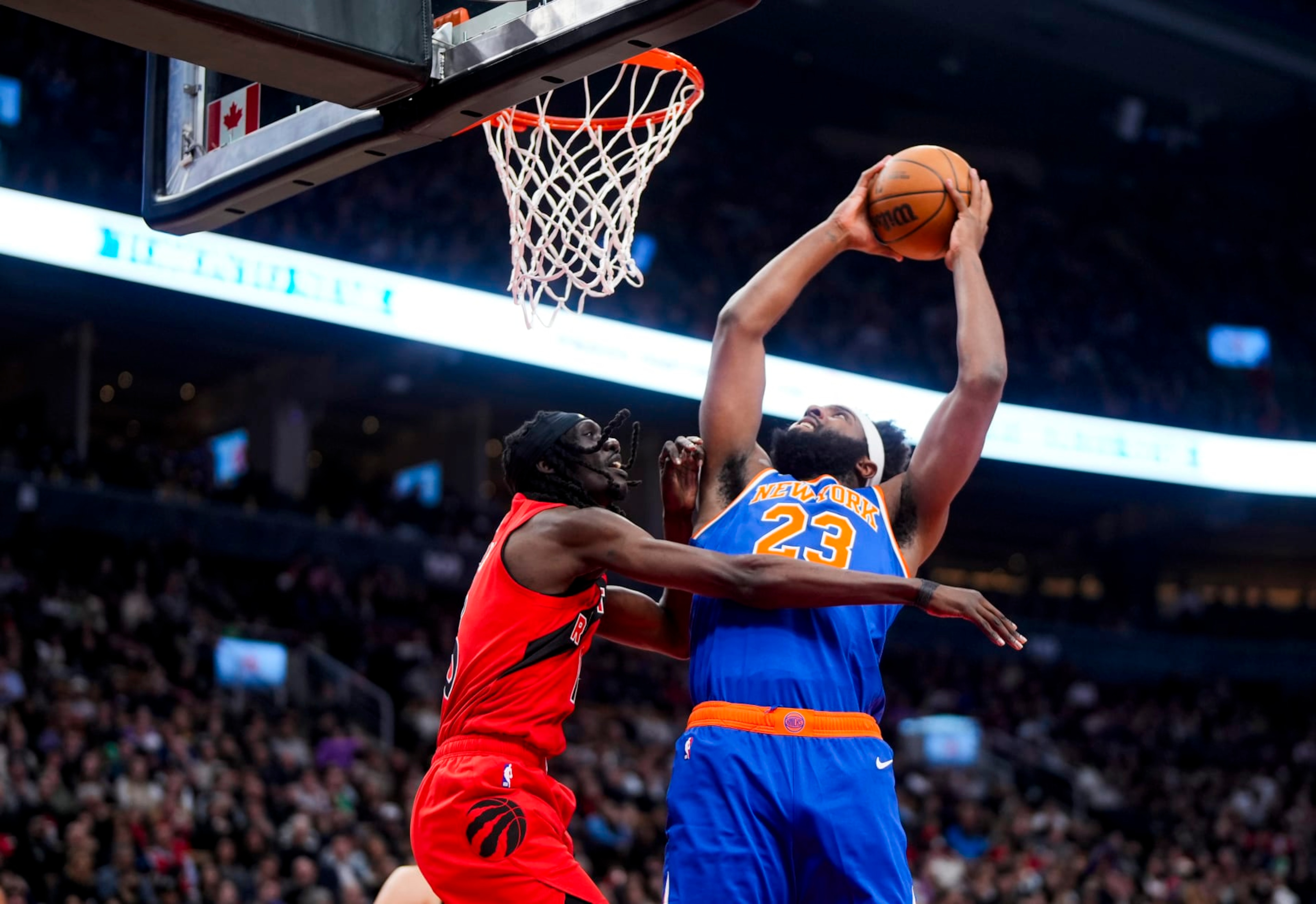 TORONTO, ON - MARCH 27: Mitchell Robinson #23 of the New York Knicks goes to the basket against Mouhamadou Gueye #16 of the Toronto Raptors during the first half of their basketball game at the Scotiabank Arena on March 27, 2024 in Toronto, Ontario, Canada. NOTE TO USER: User expressly acknowledges and agrees that, by downloading and/or using this Photograph, user is consenting to the terms and conditions of the Getty Images License Agreement. (Photo by Mark Blinch/Getty Images) TORONTO, ON - MARCH 27: Mitchell Robinson #23 of the New York Knicks goes to the basket against Mouhamadou Gueye #16 of the Toronto Raptors during the first half of their basketball game at the Scotiabank Arena on March 27, 2024 in Toronto, Ontario, Canada. NOTE TO USER: User expressly acknowledges and agrees that, by downloading and/or using this Photograph, user is consenting to the terms and conditions of the Getty Images License Agreement. (Photo by Mark Blinch/Getty Images)