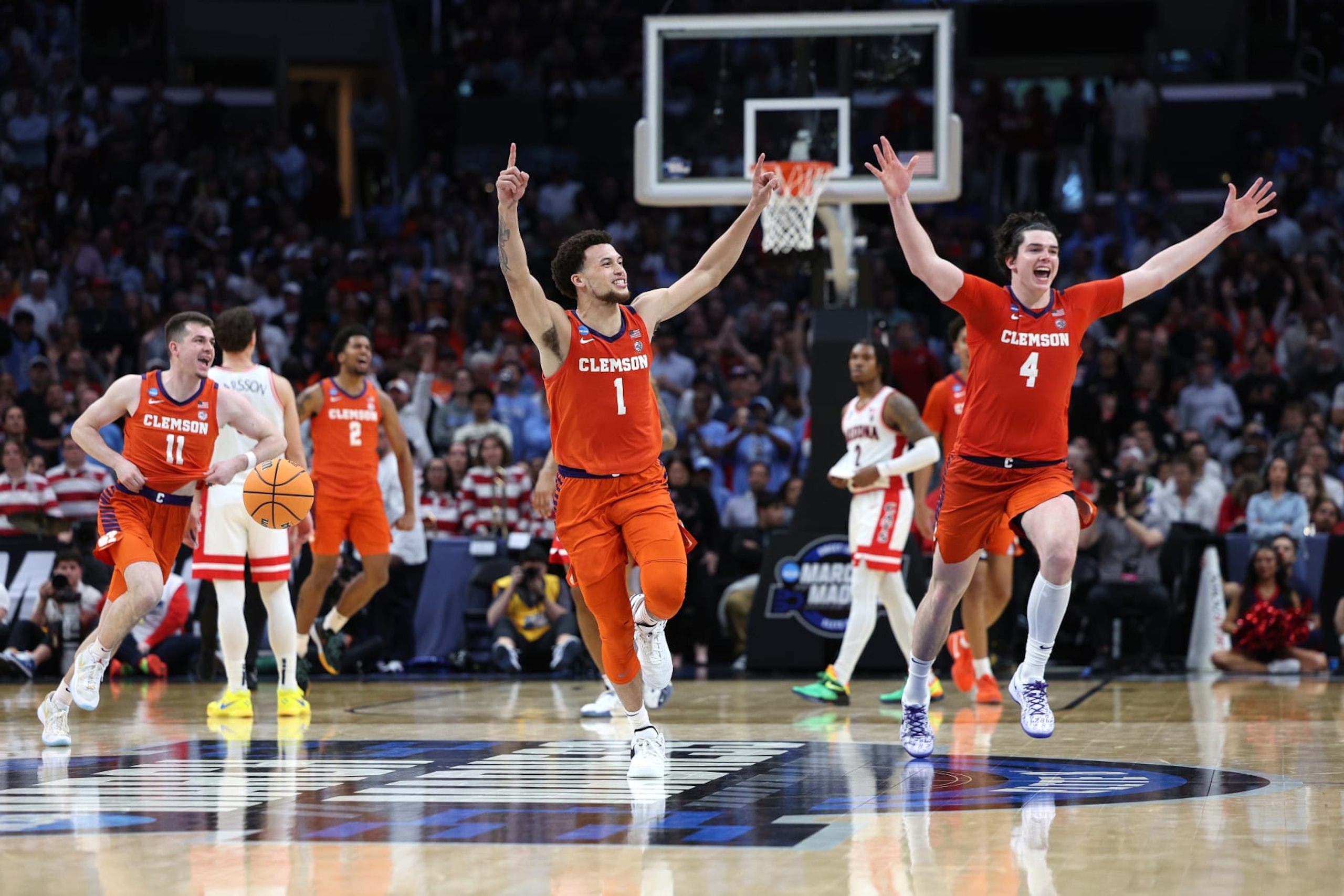 LOS ANGELES, CALIFORNIA - MARCH 28: Chase Hunter #1, Ian Schieffelin #4 and Joseph Girard III #11 of the Clemson Tigers celebrates after defeating the Arizona Wildcats during the second half in the Sweet 16 round of the NCAA Men's Basketball Tournament at Crypto.com Arena on March 28, 2024 in Los Angeles, California. The Clemson Tigers won, 77-72. (Photo by Harry How/Getty Images)