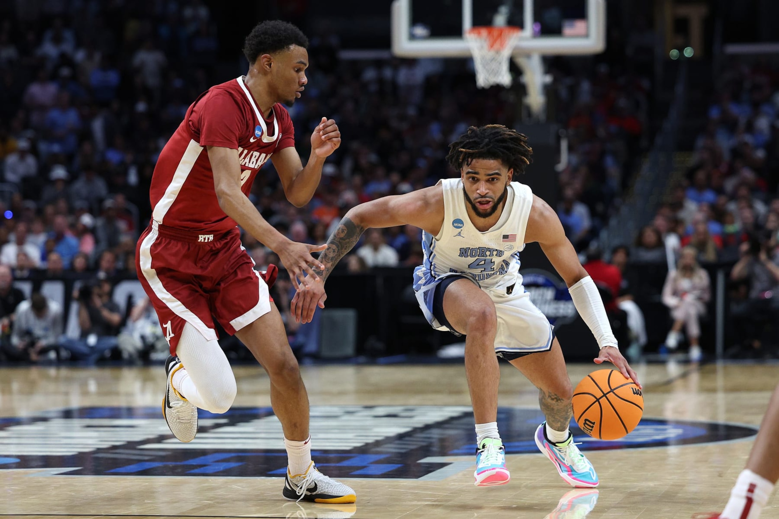 LOS ANGELES, CALIFORNIA - MARCH 28: RJ Davis #4 of the North Carolina Tar Heels drives against Rylan Griffen #3 of the Alabama Crimson Tide during the second half in the Sweet 16 round of the NCAA Men's Basketball Tournament at Crypto.com Arena on March 28, 2024 in Los Angeles, California. (Photo by Harry How/Getty Images)
