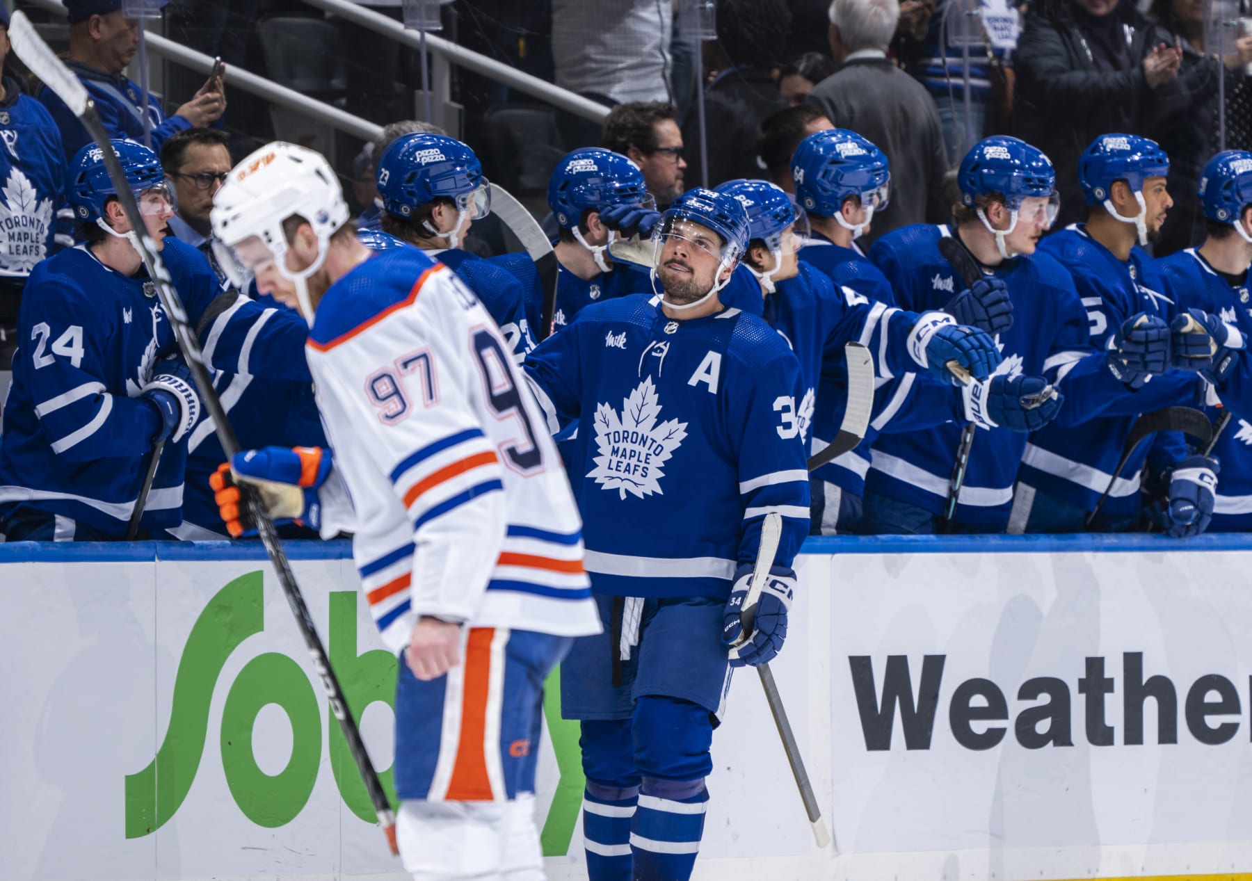TORONTO, ON - MARCH 23: Auston Matthews #34 of the Toronto Maple Leafs celebrates his goal behidn Connor McDavid #97 of the Edmonton Oilers during the third period at Scotiabank Arena on March 23, 2024 in Toronto, Ontario, Canada. (Photo by Mark Blinch/NHLI via Getty Images)
