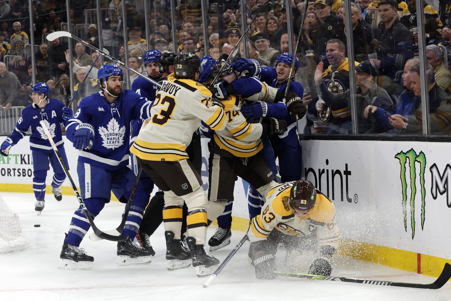 BOSTON, MA - MARCH 07: Teammates come to the aid of Boston Bruins left wing Brad Marchand (63) during a game between the Boston Bruins and the Toronto Maple Leafs on March 7, 2024, at TD Garden in Boston, Massachusetts. (Photo by Fred Kfoury III/Icon Sportswire via Getty Images)