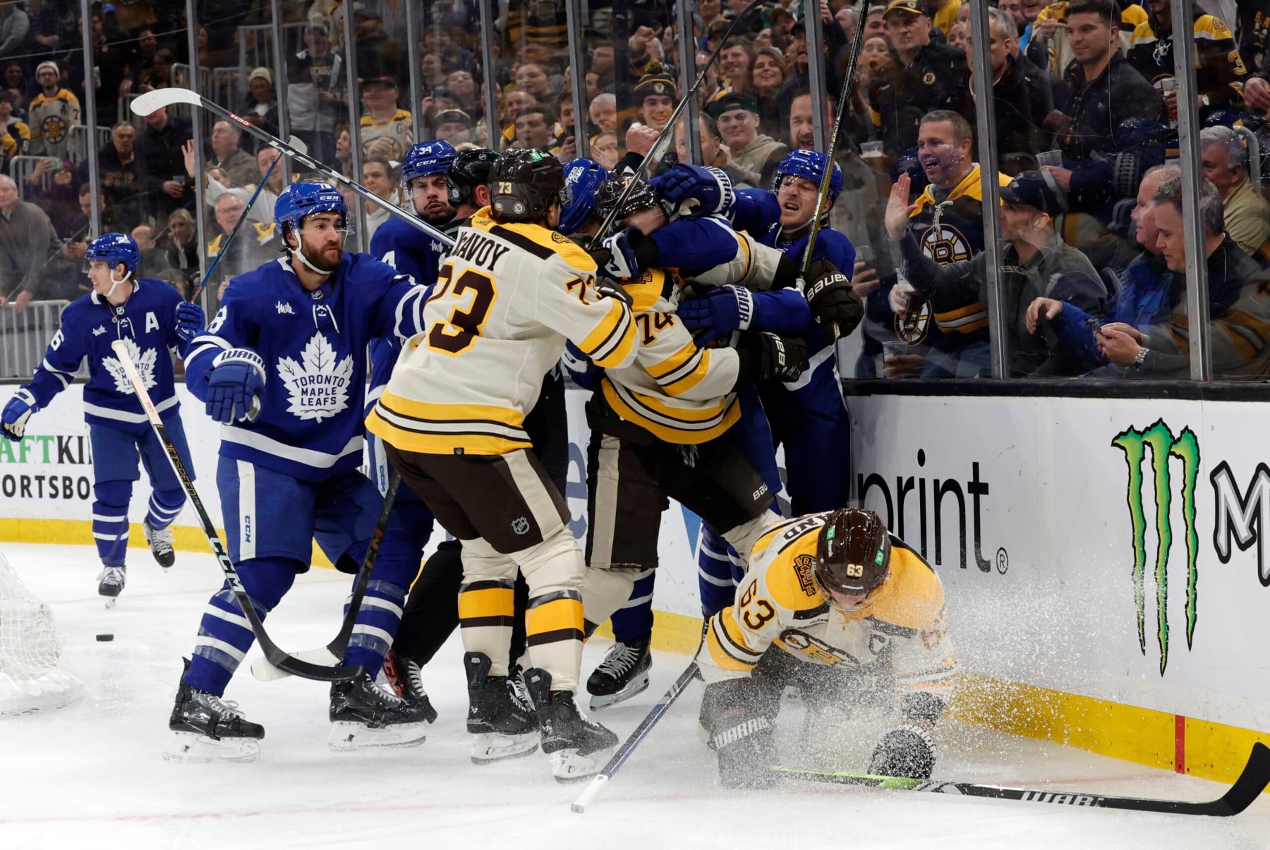 BOSTON, MA - MARCH 07: Teammates come to the aid of Boston Bruins left wing Brad Marchand (63) during a game between the Boston Bruins and the Toronto Maple Leafs on March 7, 2024, at TD Garden in Boston, Massachusetts. (Photo by Fred Kfoury III/Icon Sportswire via Getty Images)
