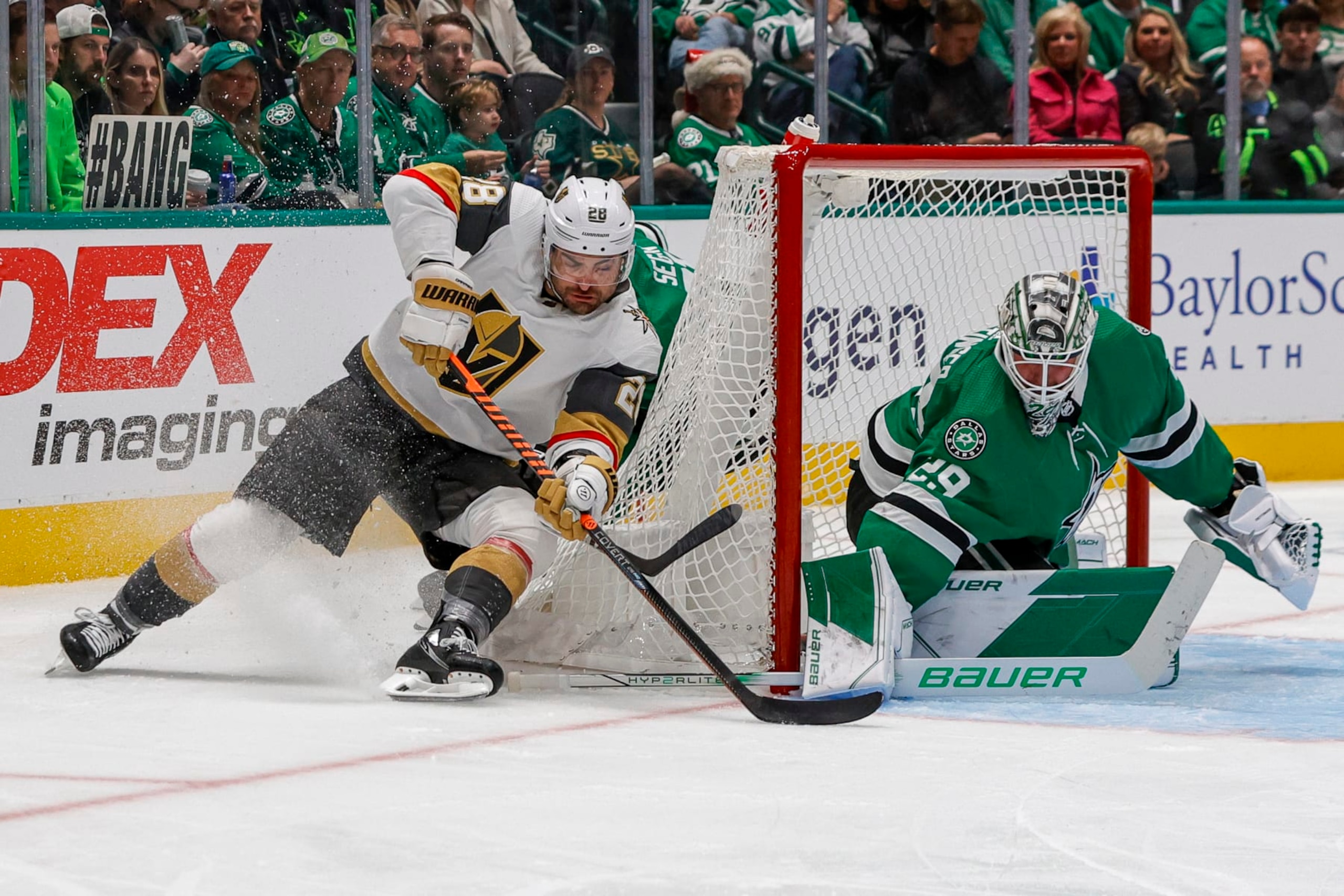 DALLAS, TX - DECEMBER 09: Vegas Golden Knights left wing William Carrier (28) skates around the net with the puck as Dallas Stars goaltender Jake Oettinger (29) blocks a shot during the game between the Dallas Stars and the Vegas Golden Knights on December 9, 2023 at American Airlines Center in Dallas, Texas. (Photo by Matthew Pearce/Icon Sportswire via Getty Images)