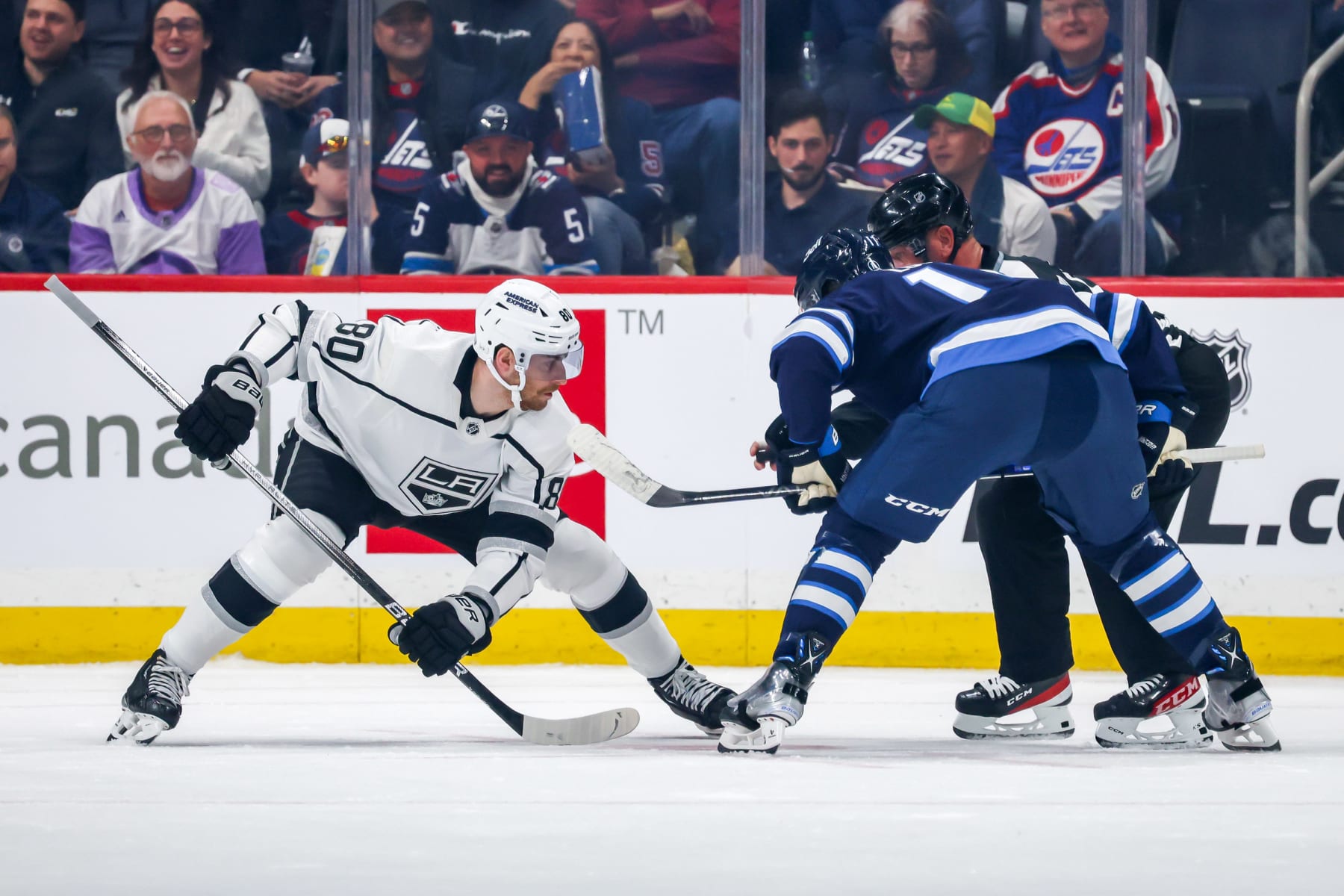 WINNIPEG, CANADA - OCTOBER 17: Pierre-Luc Dubois #80 of the Los Angeles Kings and Adam Lowry #17 of the Winnipeg Jets get set during a first period face-off at the Canada Life Centre on October 17, 2023 in Winnipeg, Manitoba, Canada. (Photo by Jonathan Kozub/NHLI via Getty Images) 