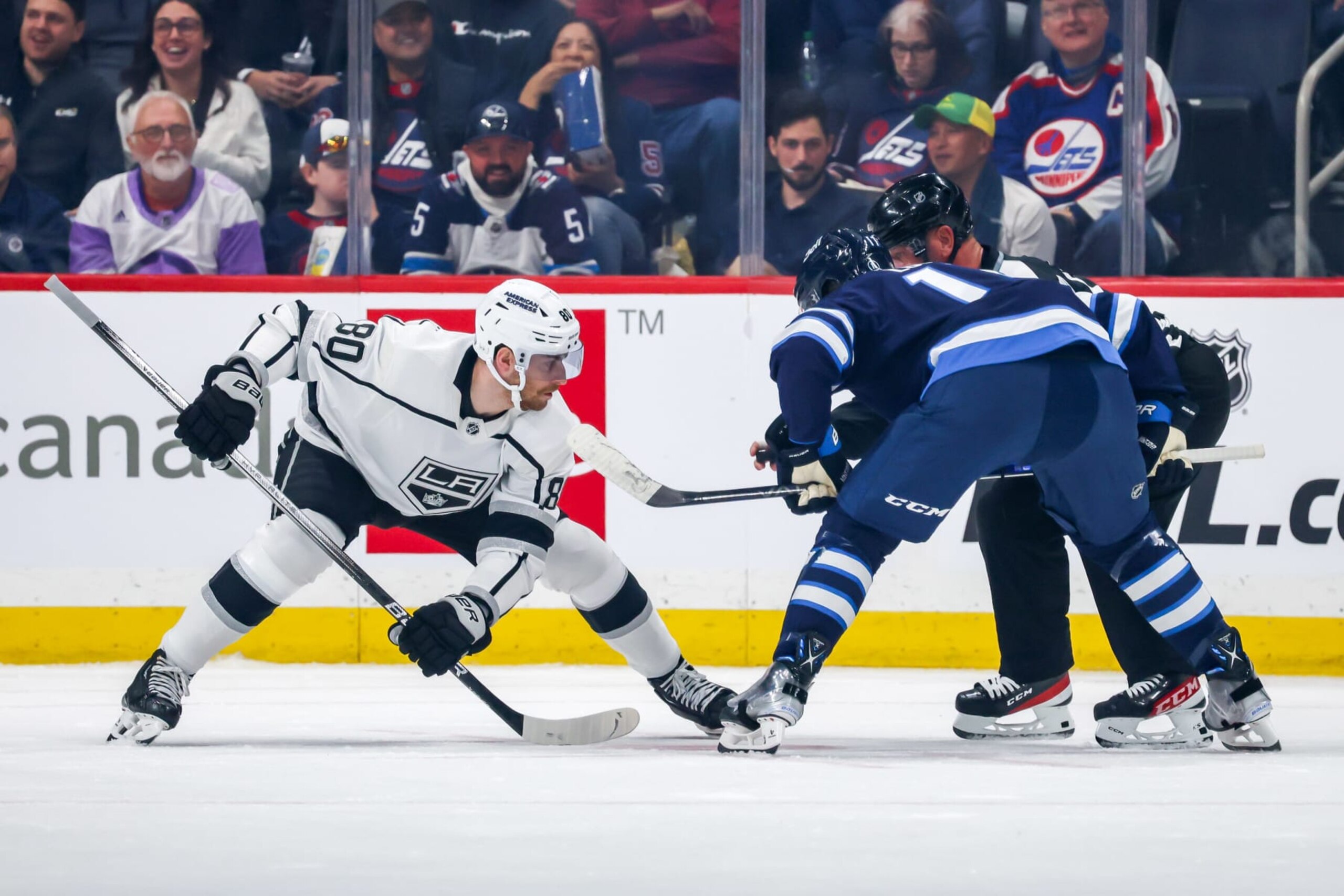 WINNIPEG, CANADA - OCTOBER 17: Pierre-Luc Dubois #80 of the Los Angeles Kings and Adam Lowry #17 of the Winnipeg Jets get set during a first period face-off at the Canada Life Centre on October 17, 2023 in Winnipeg, Manitoba, Canada. (Photo by Jonathan Kozub/NHLI via Getty Images) 