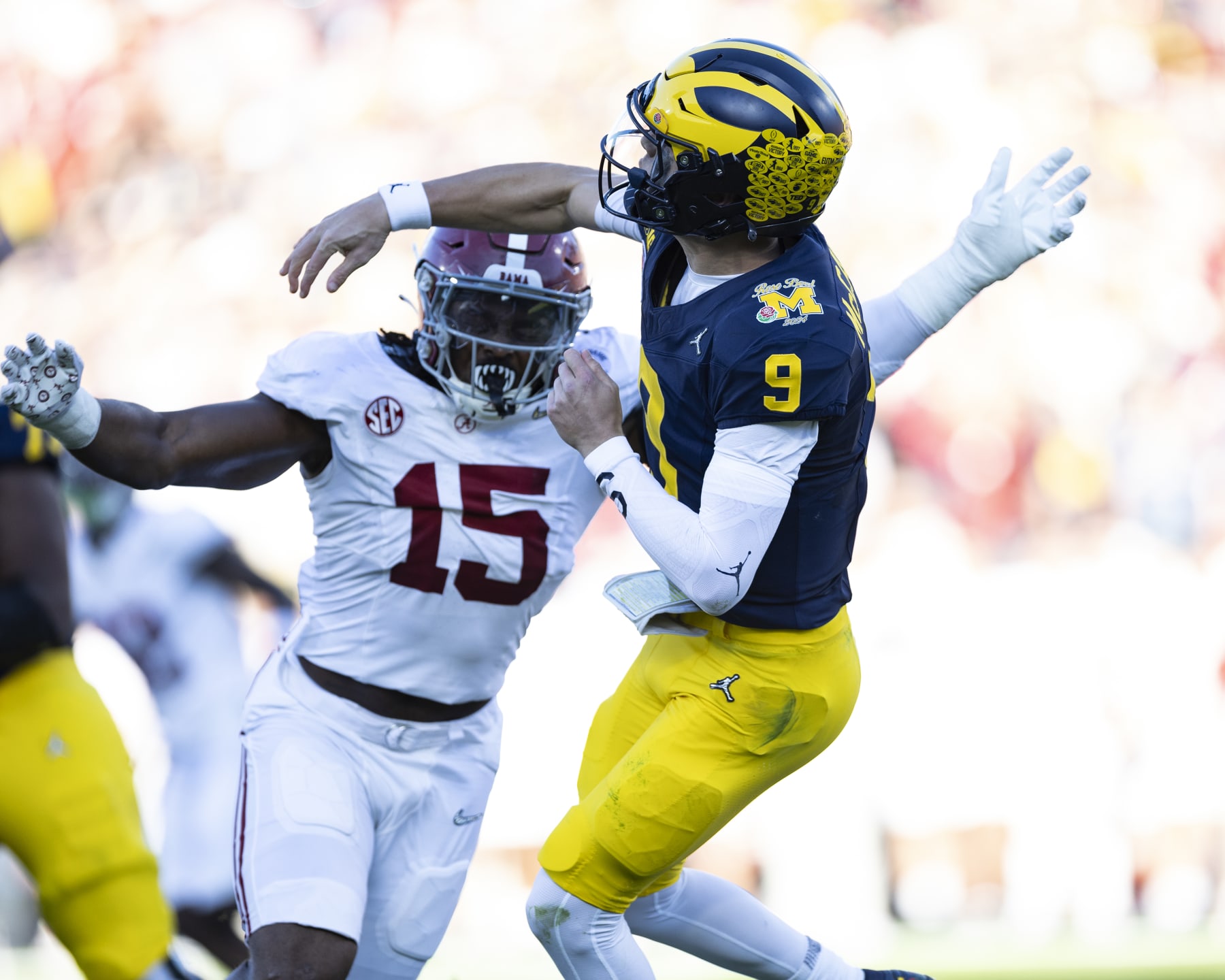 PASADENA, CA - JANUARY 01: J.J.McCarthy #9 of the Michigan Wolverines is hit by Dallas Turner #15 of the Alabama Crimson Tide during the Rose Bowl between University of Alabama and University of Michigan at the Rose Bowl on January 1, 2024 in Pasadena, California. (Photo by Steve Limentani/ISI Photos/Getty Images)