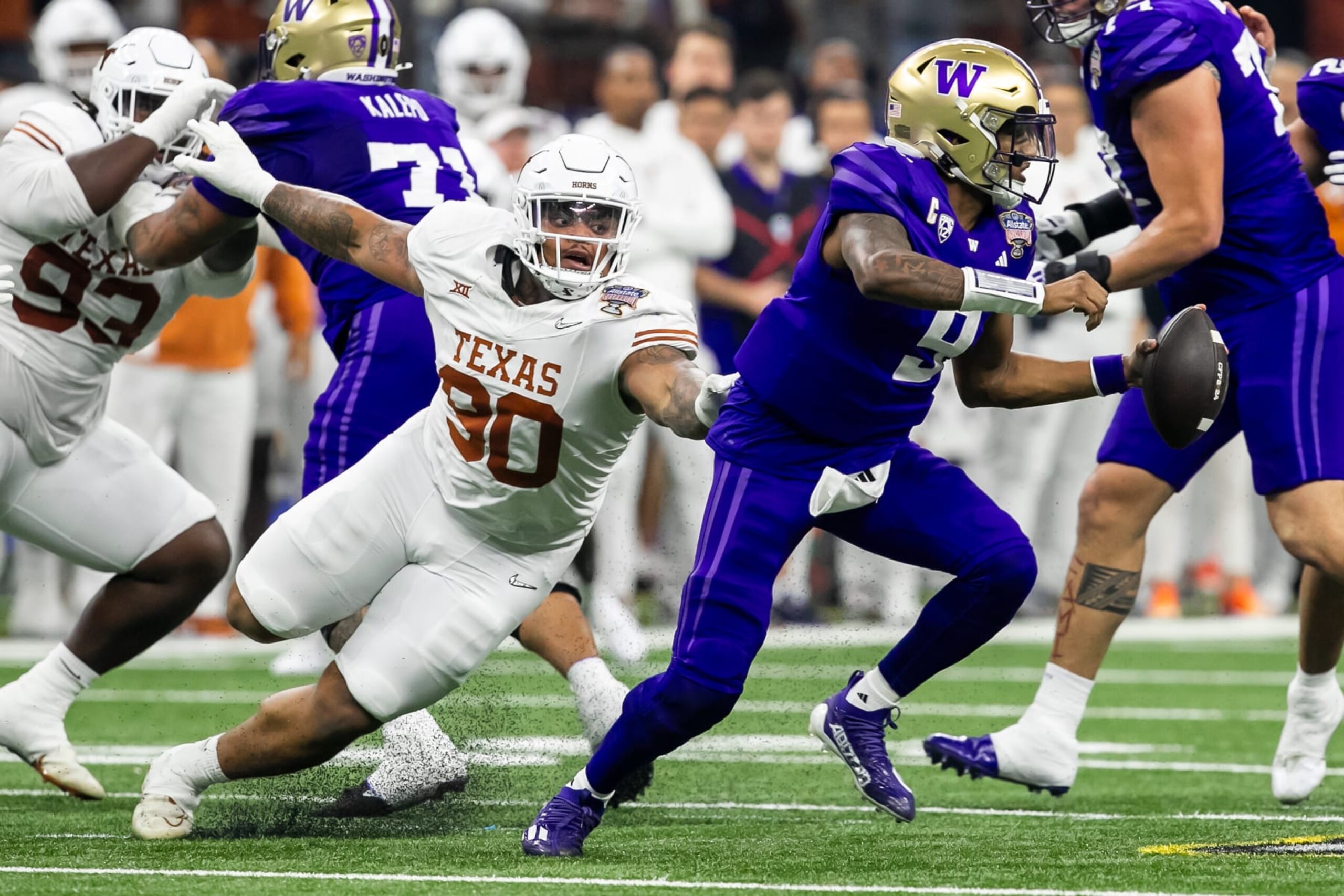 NEW ORLEANS, LA - JANUARY 01: Washington quarterback Michael Penix Jr. (9) attempts to avoid the tackle of Texas defensive lineman Byron Murphy II (90) during the Allstate Sugar Bowl playoff game between the Texas Longhorns and the Washington Huskies on Monday, January 1, 2024 at Caesars Superdome in New Orleans, LA. (Photo by Nick Tre. Smith/Icon Sportswire via Getty Images) NEW ORLEANS, LA - JANUARY 01: Washington quarterback Michael Penix Jr. (9) attempts to avoid the tackle of Texas defensive lineman Byron Murphy II (90) during the Allstate Sugar Bowl playoff game between the Texas Longhorns and the Washington Huskies on Monday, January 1, 2024 at Caesars Superdome in New Orleans, LA. (Photo by Nick Tre. Smith/Icon Sportswire via Getty Images)