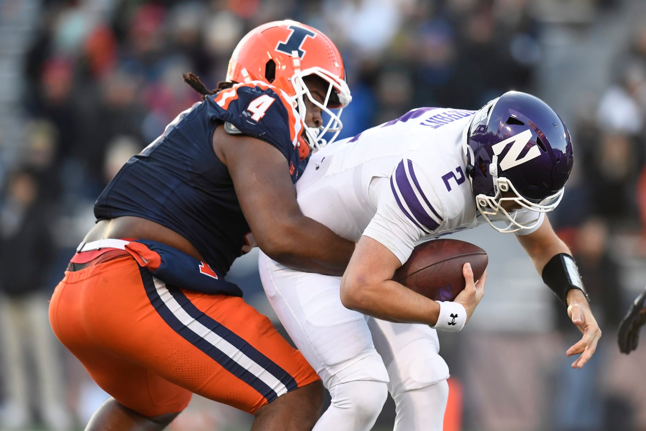 CHAMPAIGN, IL - NOVEMBER 25: Illinois Fighting Illini Defensive Tackle Jer'Zhan Newton (4) sacks Northwestern Wildcats Quarterback Ben Bryant (2) during the college football game between the Northwestern Wildcats and the Illinois Fighting Illini on November 25, 2023, at Memorial Stadium in Champaign, Illinois. (Photo by Michael Allio/Icon Sportswire via Getty Images) CHAMPAIGN, IL - NOVEMBER 25: Illinois Fighting Illini Defensive Tackle Jer'Zhan Newton (4) sacks Northwestern Wildcats Quarterback Ben Bryant (2) during the college football game between the Northwestern Wildcats and the Illinois Fighting Illini on November 25, 2023, at Memorial Stadium in Champaign, Illinois. (Photo by Michael Allio/Icon Sportswire via Getty Images)