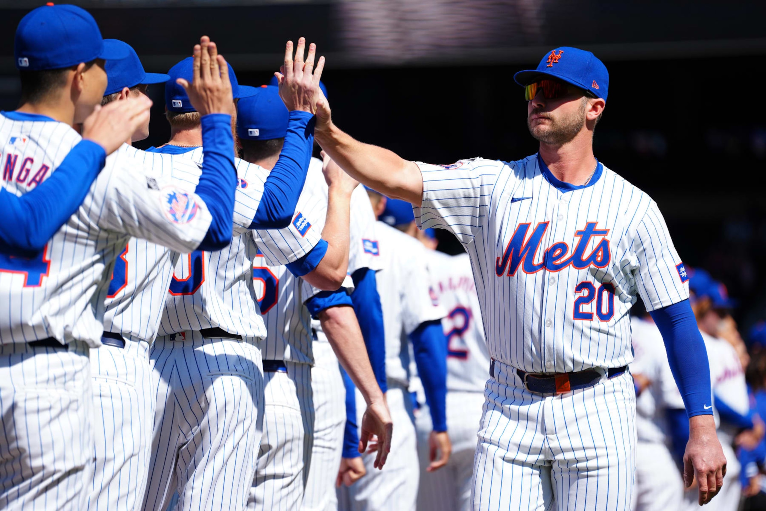 NEW YORK, NY - MARCH 29:  Pete Alonso #20 of the New York Mets is greeted by teammates during player introductions prior to the game between the Milwaukee Brewers and the New York Mets at Citi Field on Friday, March 29, 2024 in New York, New York. (Photo by Mary DeCicco/MLB Photos via Getty Images)