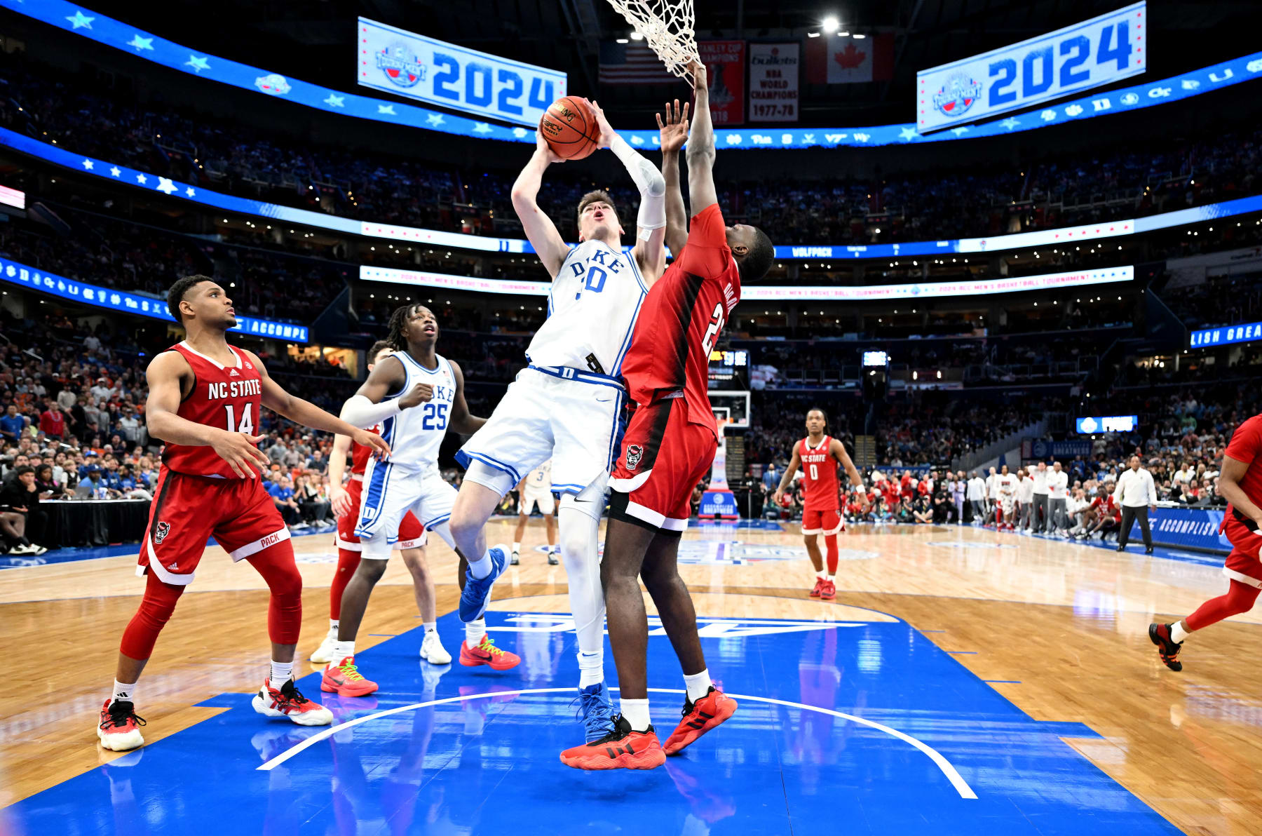 WASHINGTON, DC - MARCH 14: Kyle Filipowski #30 of the Duke Blue Devils drives to the basket in the second half against Mohamed Diarra #23 of the North Carolina State Wolfpack in the Quarterfinals of the ACC Men's Basketball Tournament at Capital One Arena on March 14, 2024 in Washington, DC. (Photo by Greg Fiume/Getty Images)