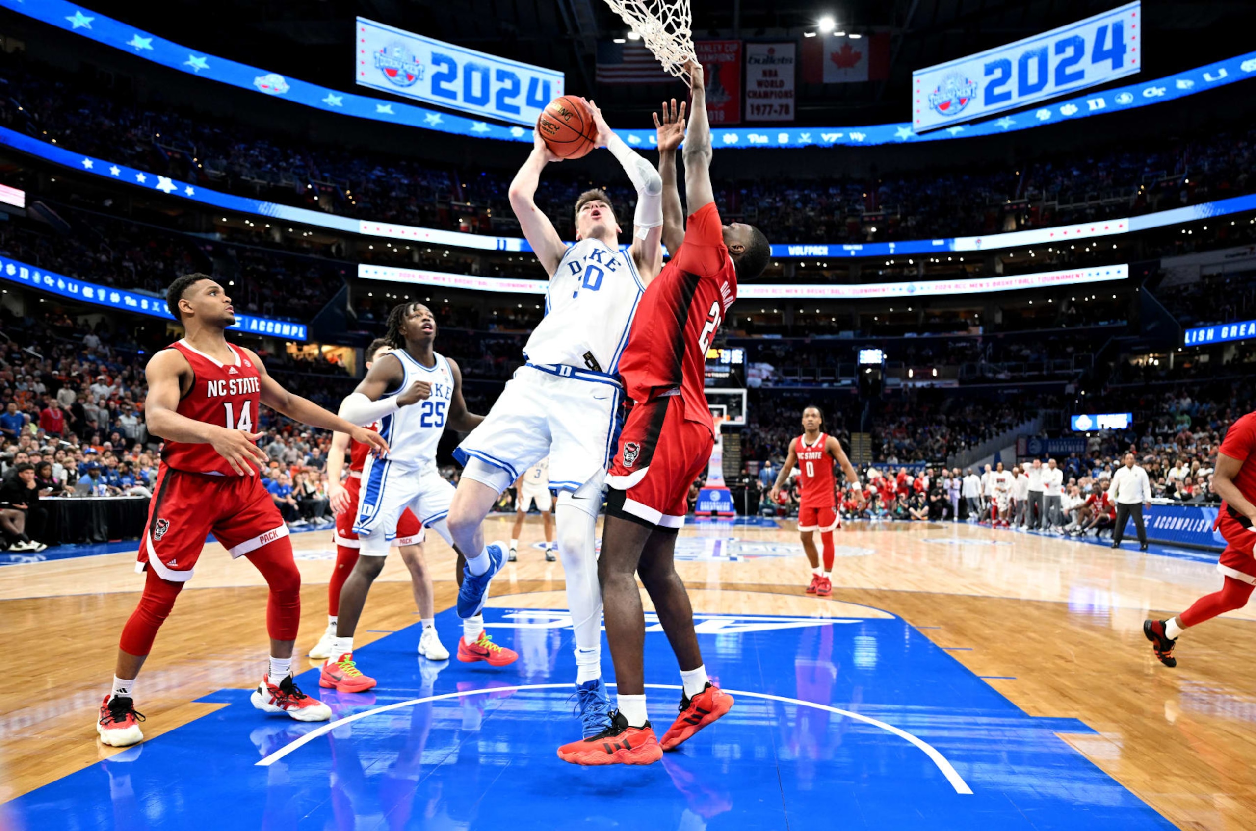 WASHINGTON, DC - MARCH 14: Kyle Filipowski #30 of the Duke Blue Devils drives to the basket in the second half against Mohamed Diarra #23 of the North Carolina State Wolfpack in the Quarterfinals of the ACC Men's Basketball Tournament  at Capital One Arena on March 14, 2024 in Washington, DC. (Photo by Greg Fiume/Getty Images)