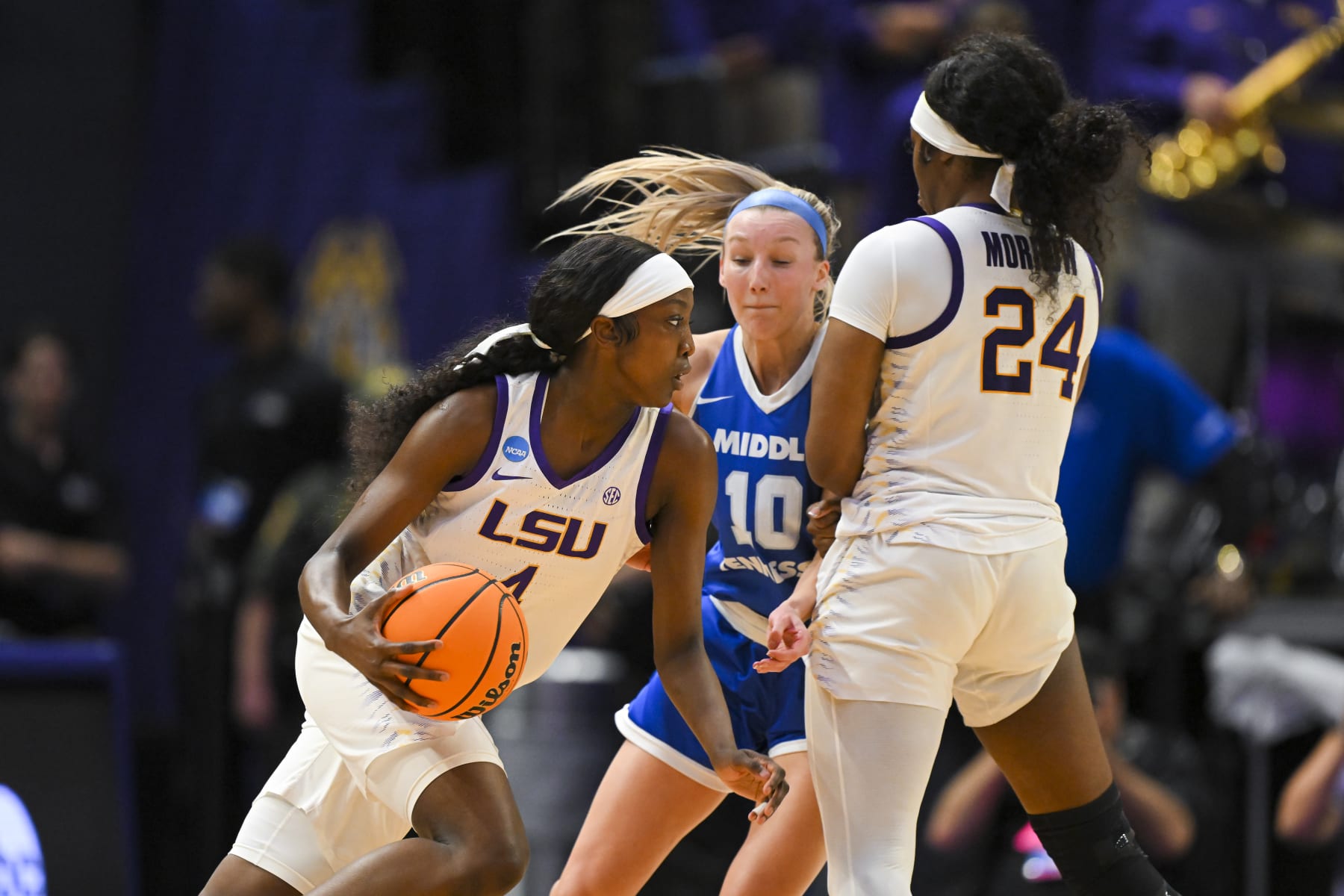BATON ROUGE, LOUISIANA - MARCH 24: Flau'jae Johnson #4 of the LSU Tigers dribbles past Jalynn Gregory #10 of the Middle Tennessee Blue Raiders as Aneesah Morrow #24 of the LSU Tigers sets a screen during the third quarter during the second round of the 2024 NCAA Women's Basketball Tournament held at Pete Maravich Assembly Center on March 24, 2024 in Baton Rouge, Louisiana. (Photo by Andy Hancock/NCAA Photos/NCAA Photos via Getty Images)