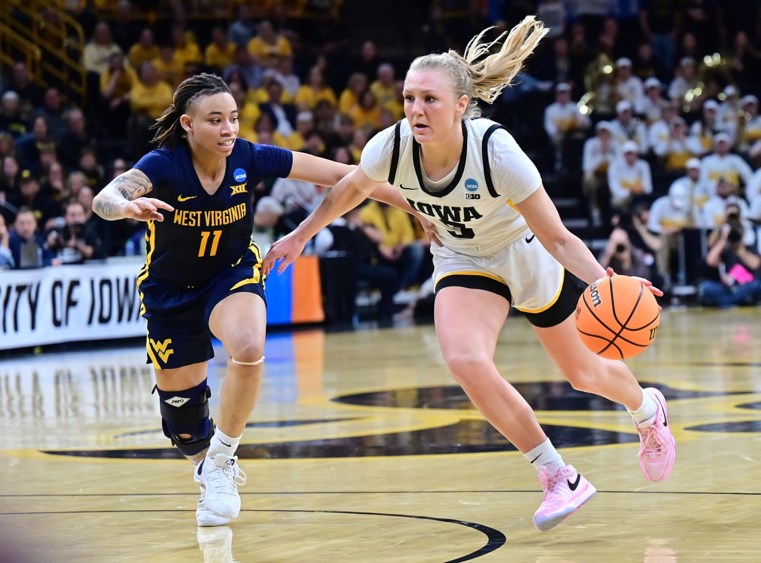 IOWA CITY, IA - MARCH 25: Iowa guard Sydney Affolter (3) drives to the basket as West Virginia guard JJ Quinerly (11) defends during the West Virginia Mountaineers game versus the Iowa Hawkeyes in the second round of the NCAA Division I Women's Championship on March 25, 2024, at Carver-Hawkeye Arena in Iowa City, IA. (Photo by Keith Gillett/Icon Sportswire via Getty Images)