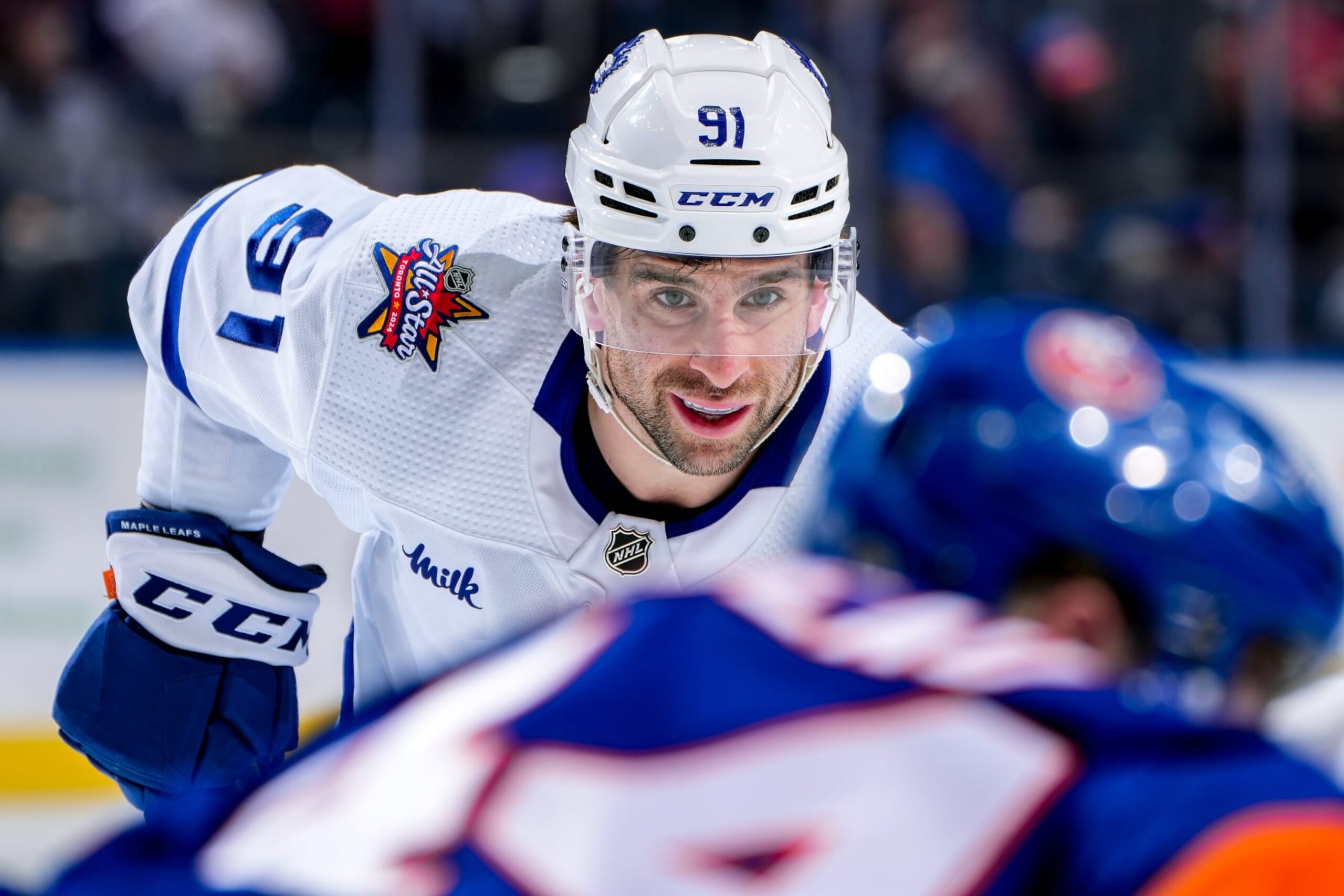 ELMONT, NEW YORK - JANUARY 11:  John Tavares #91 of the Toronto Maple Leafs waits for play to begin against the New York Islanders during the second period at UBS Arena on January 11, 2024 in Elmont, New York. (Photo by Mike Stobe/NHLI via Getty Images)